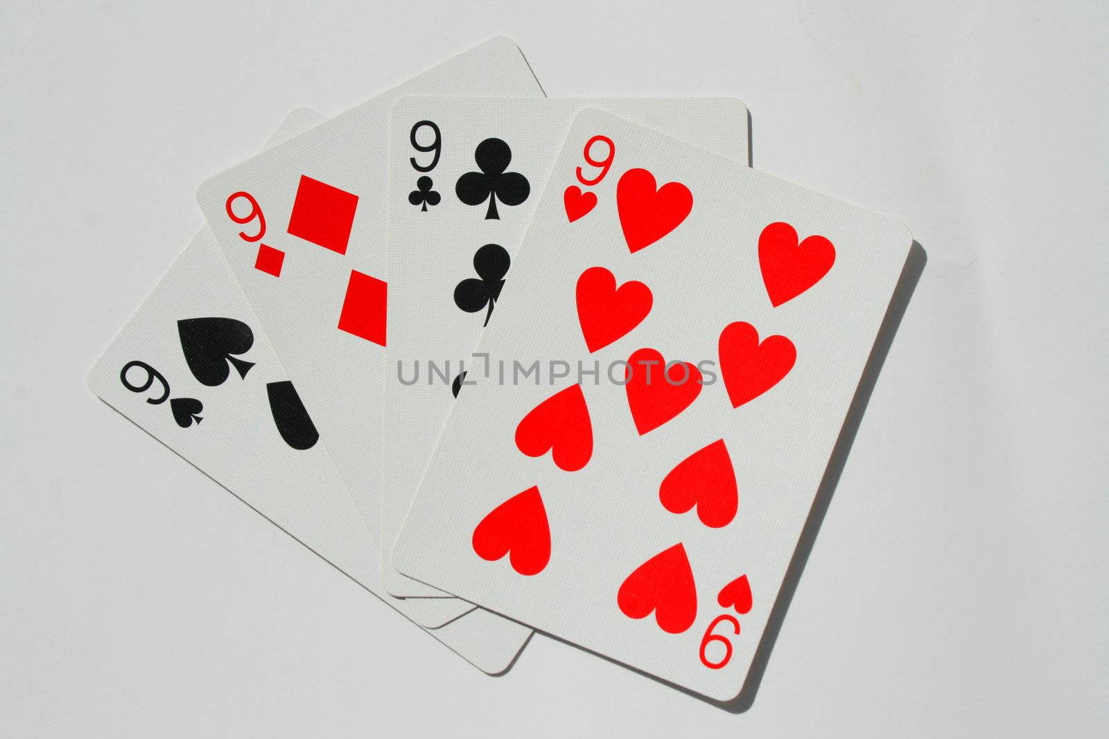Close up of four nines on a white background.
