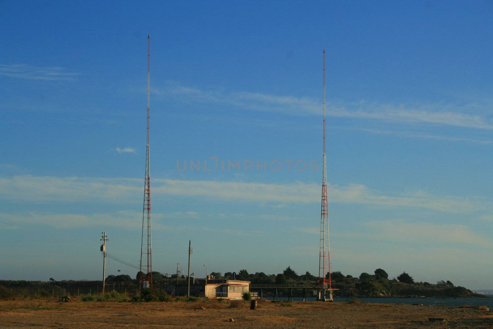 Tall radio towers over blue sky.
