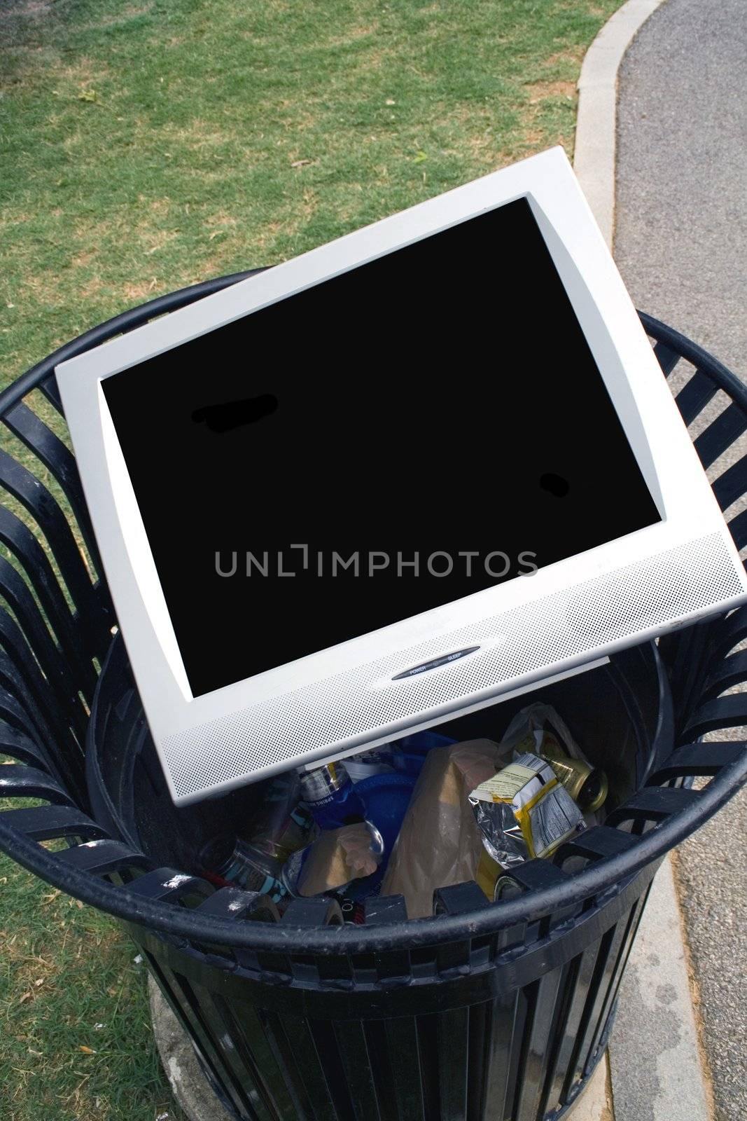 Television or Monitor laying in a trash can