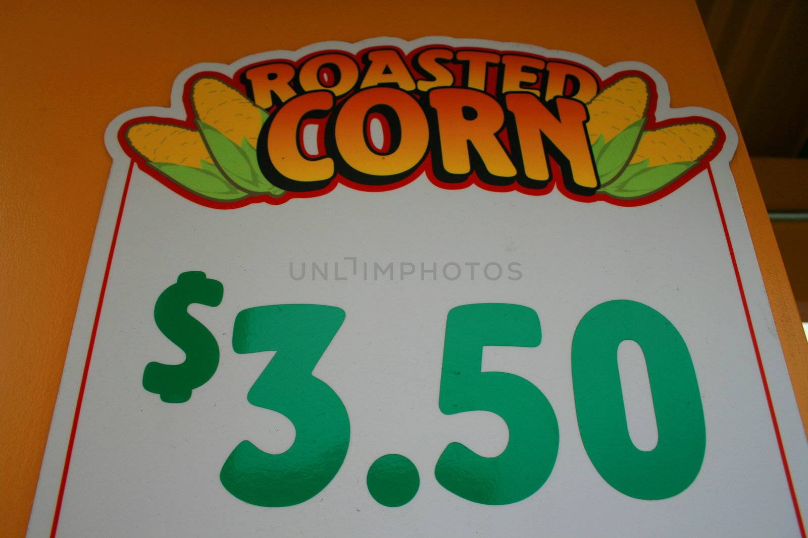 Close up of a roasted corn price sign.