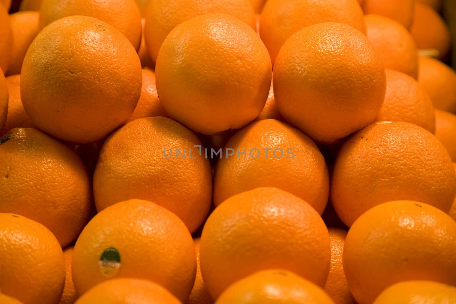Pile of Bright Oranges Fruit

Trademark removed.

Resubmit--In response to comments from reviewer have further processed image to reduce noise, sharpen focus and adjust lighting.
