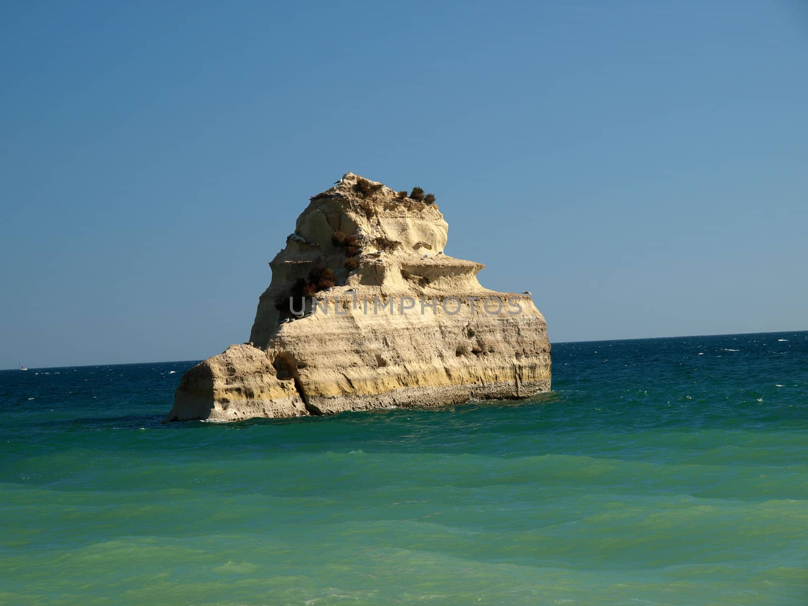 A lonely rock in the ocean. The effect of erosion