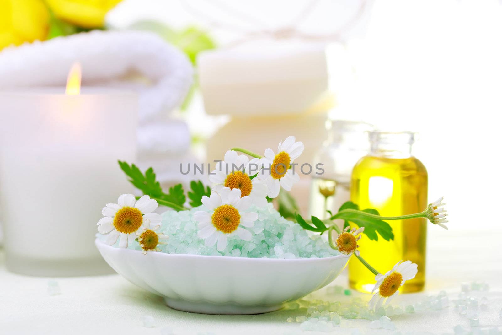 Spa relaxation theme with flowers, bath salt, essential oil, towels and candles