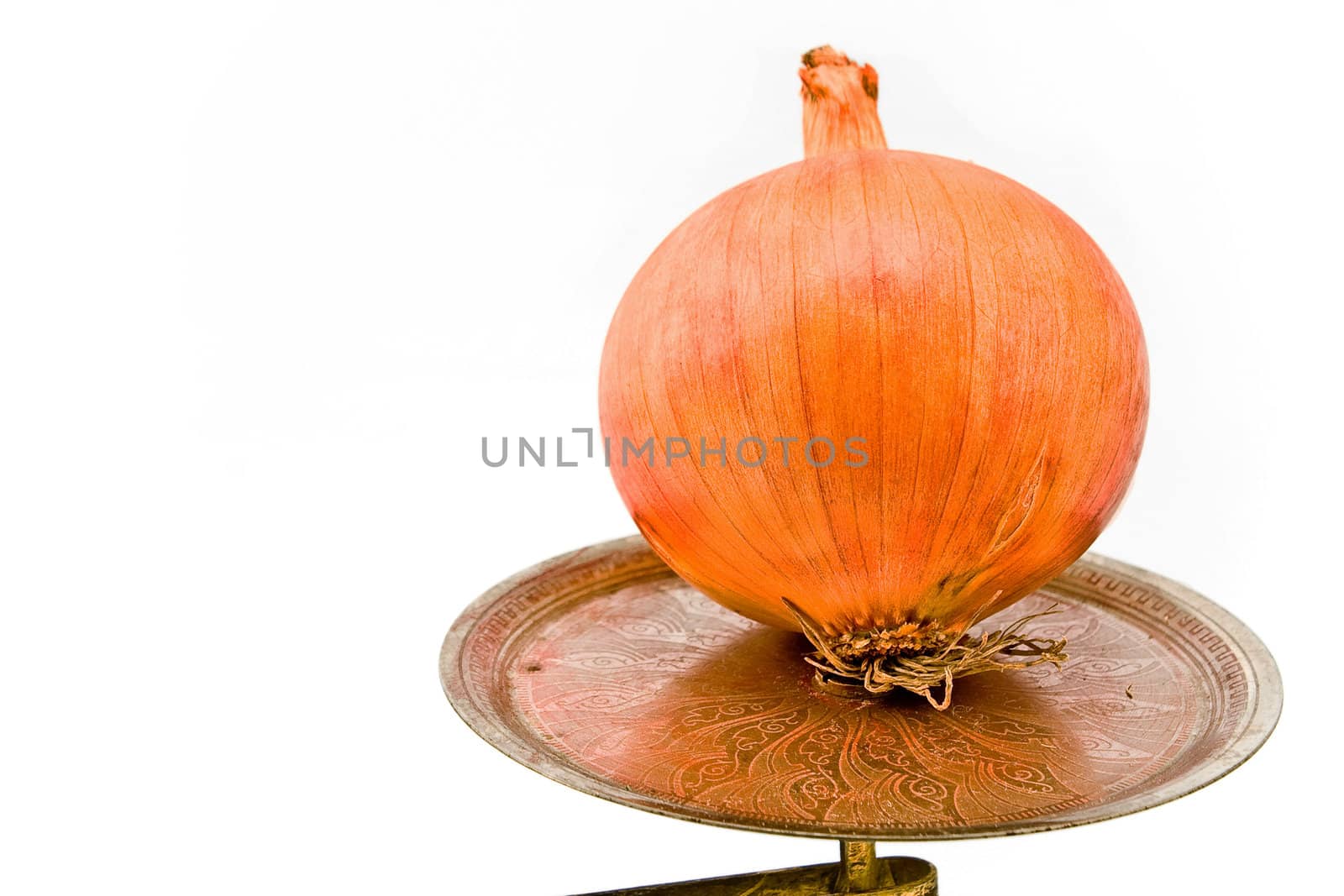 Onion on old scale plate isolated on white