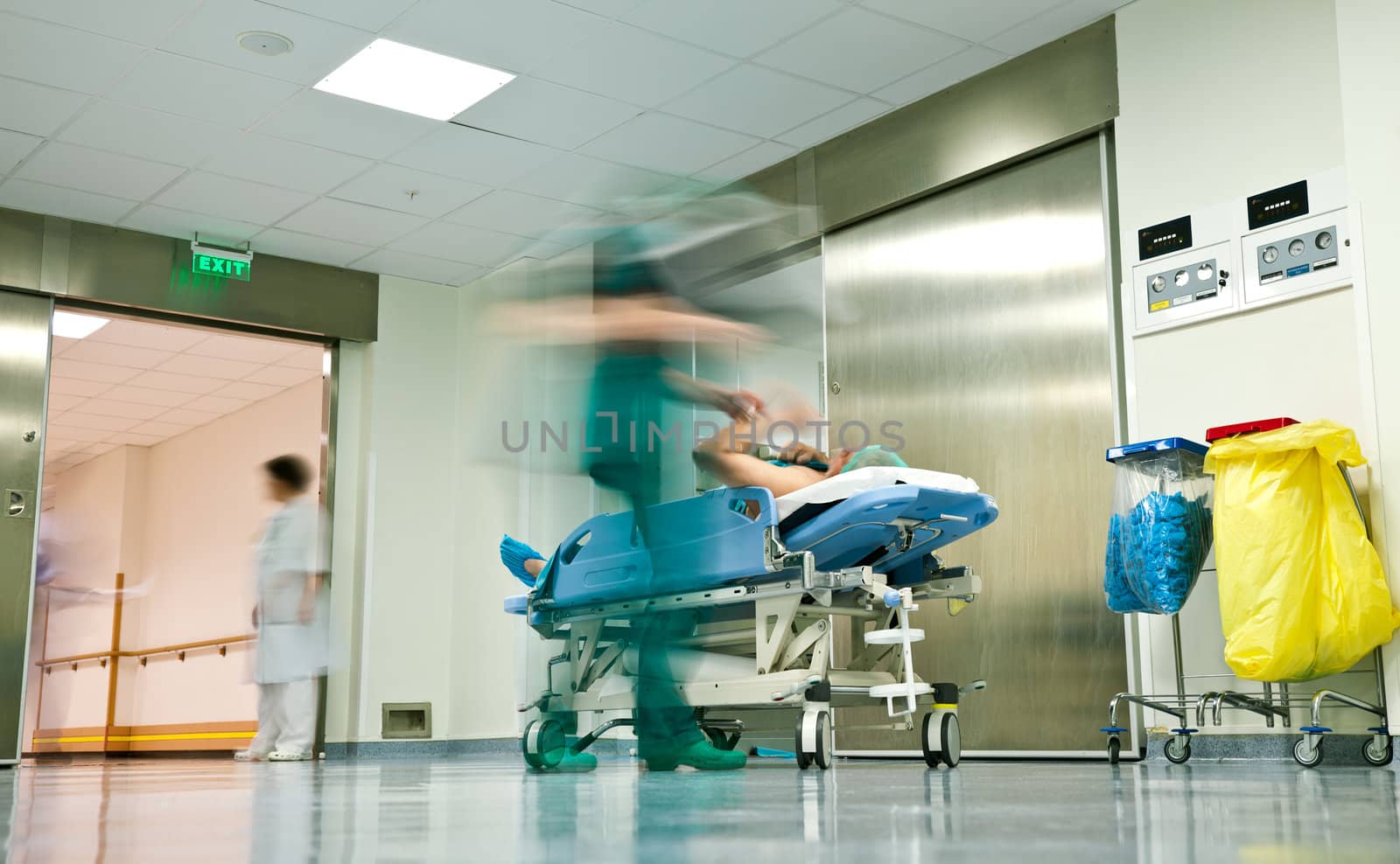 Blurred figures of people with medical uniforms transporting a patient to surgery