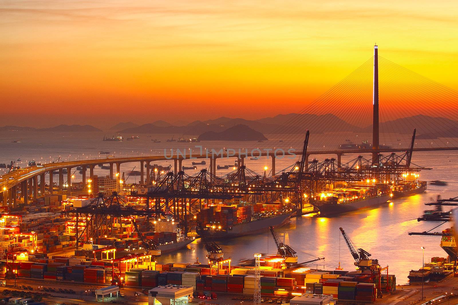 Port warehouse with cargoes and containers at sunset