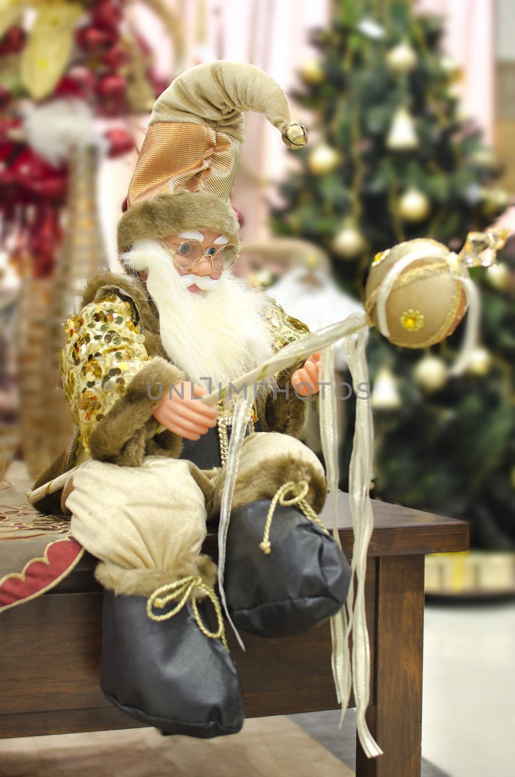 santa claus statue decoration posing  sitting with new year green pine background