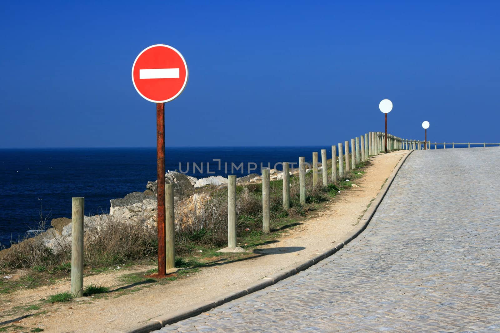 Sign on the road close to ocean by nataliamylova