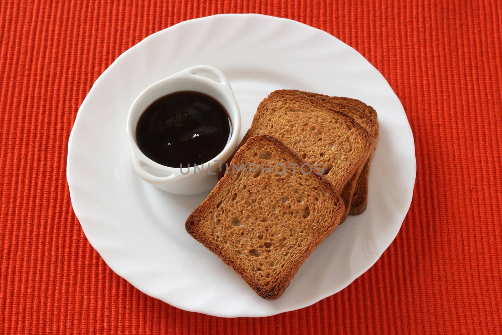 toasts with jam on plate by nataliamylova