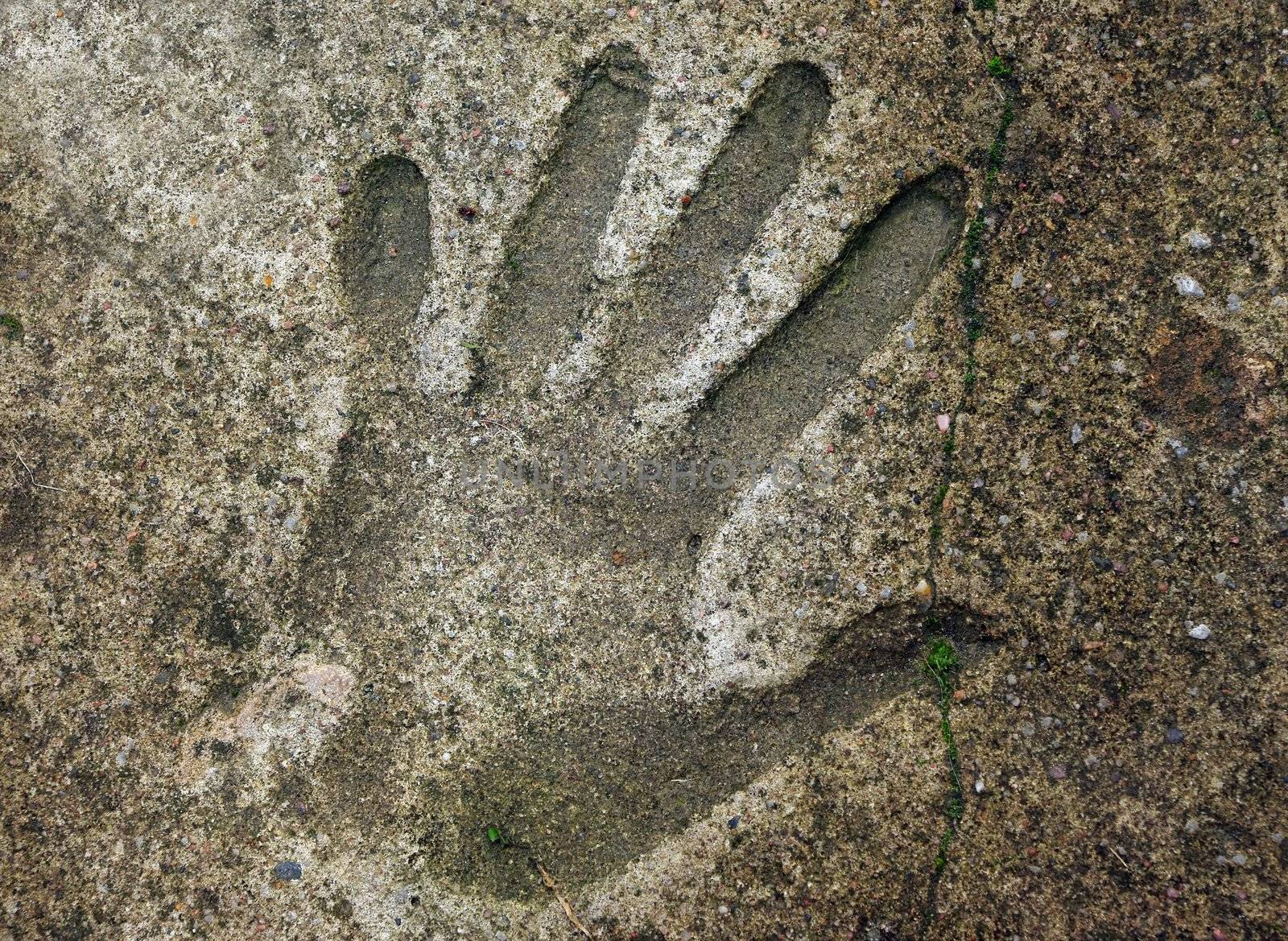Human handprint in old weathered concrete floor