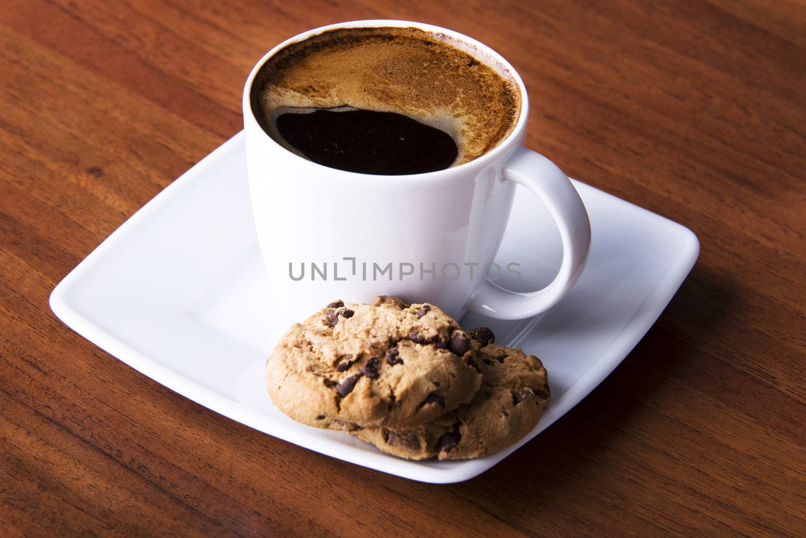 Coffee with cookie on table