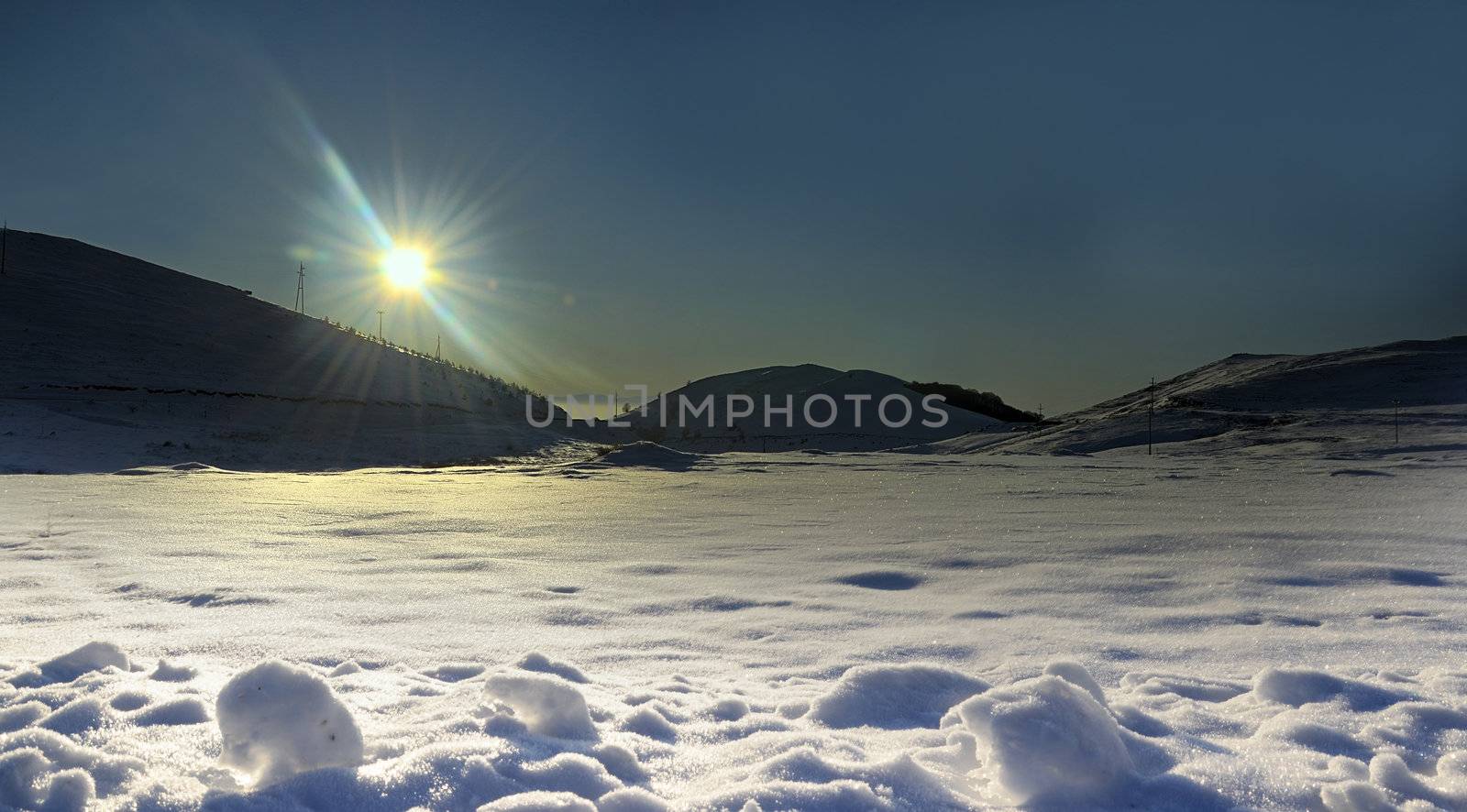 winter sun on the mountain snow background by zefart
