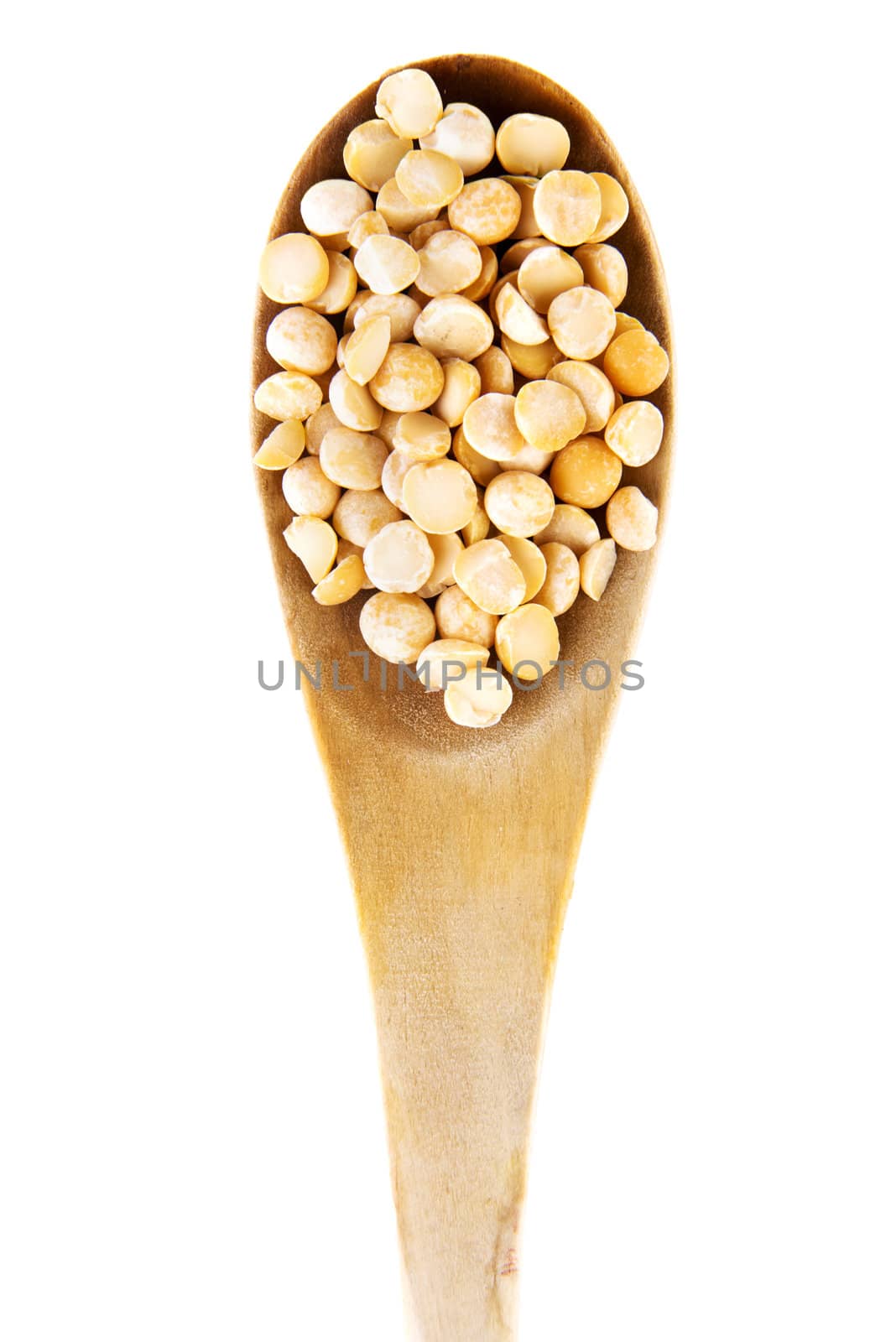 Dry peas on wooden spoon, isolated on white