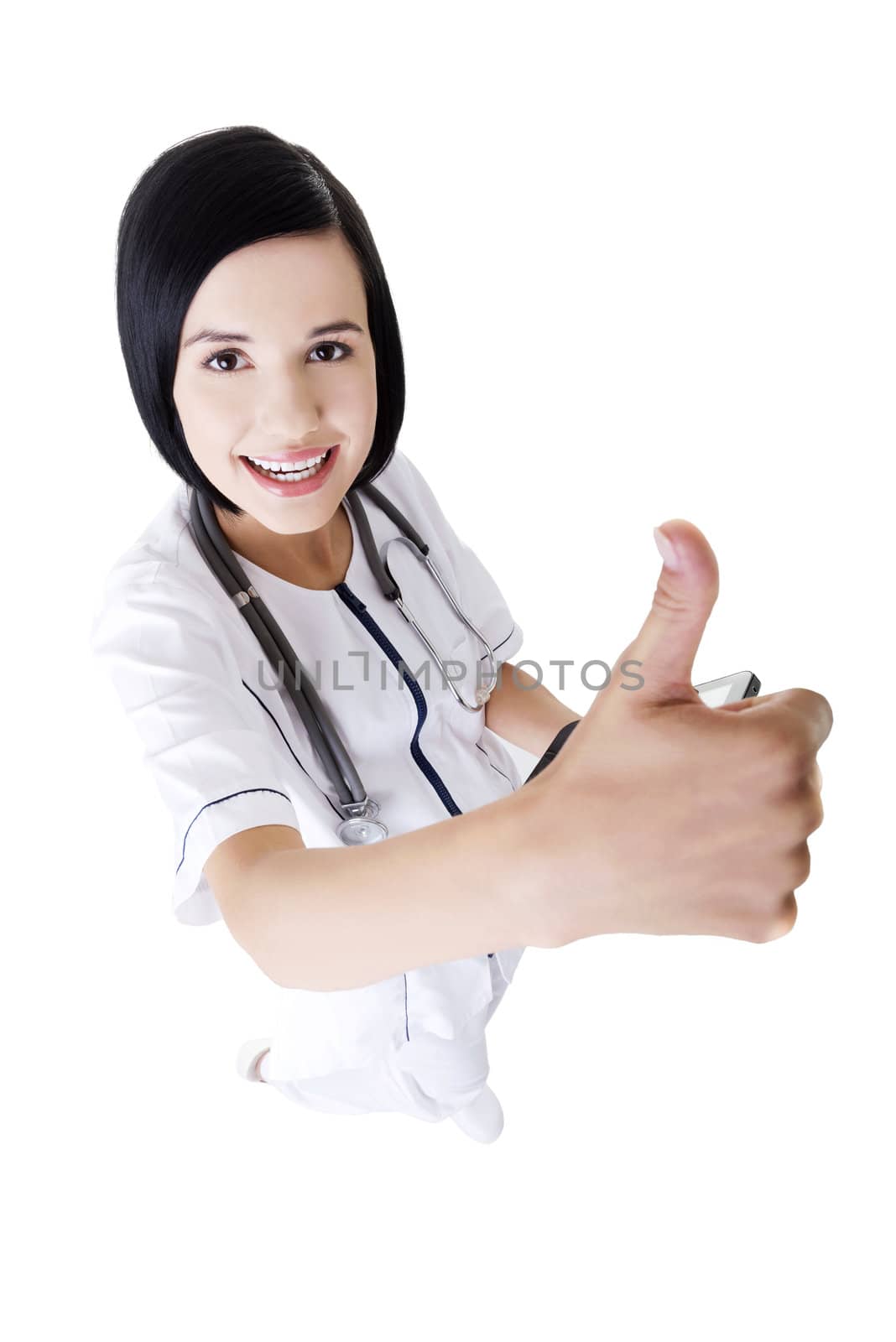 Young female doctor or nurse gesturing OK , isolated