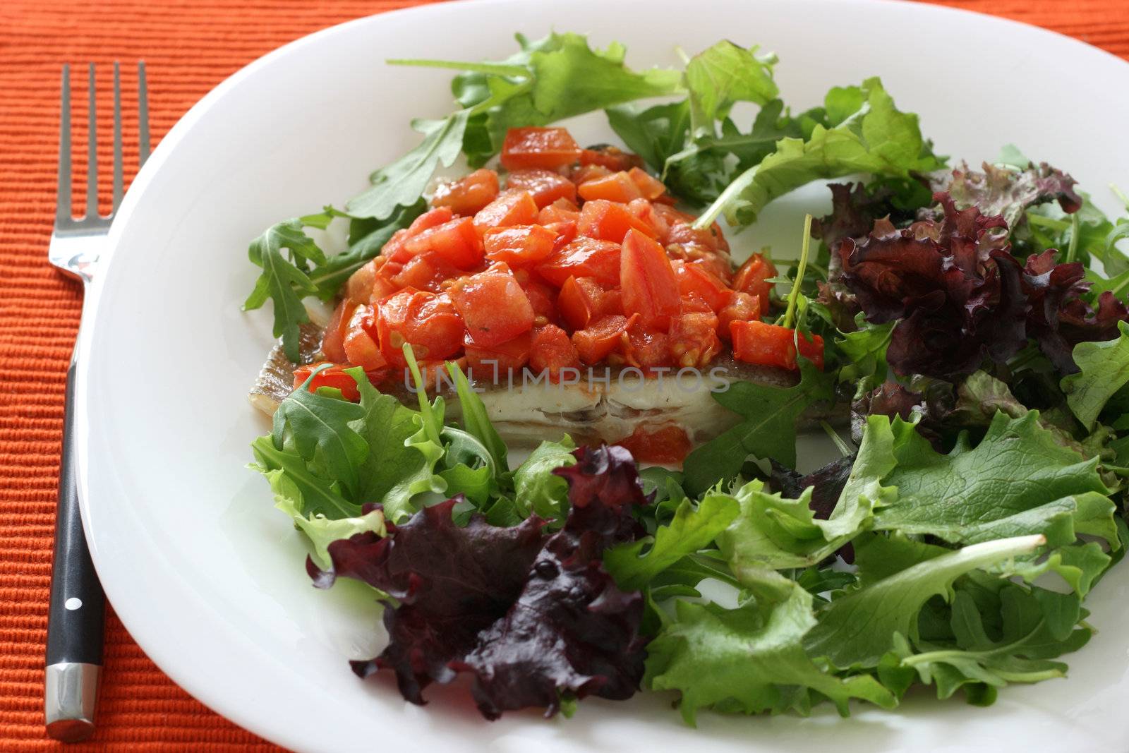 fried fish with cut tomato and salad