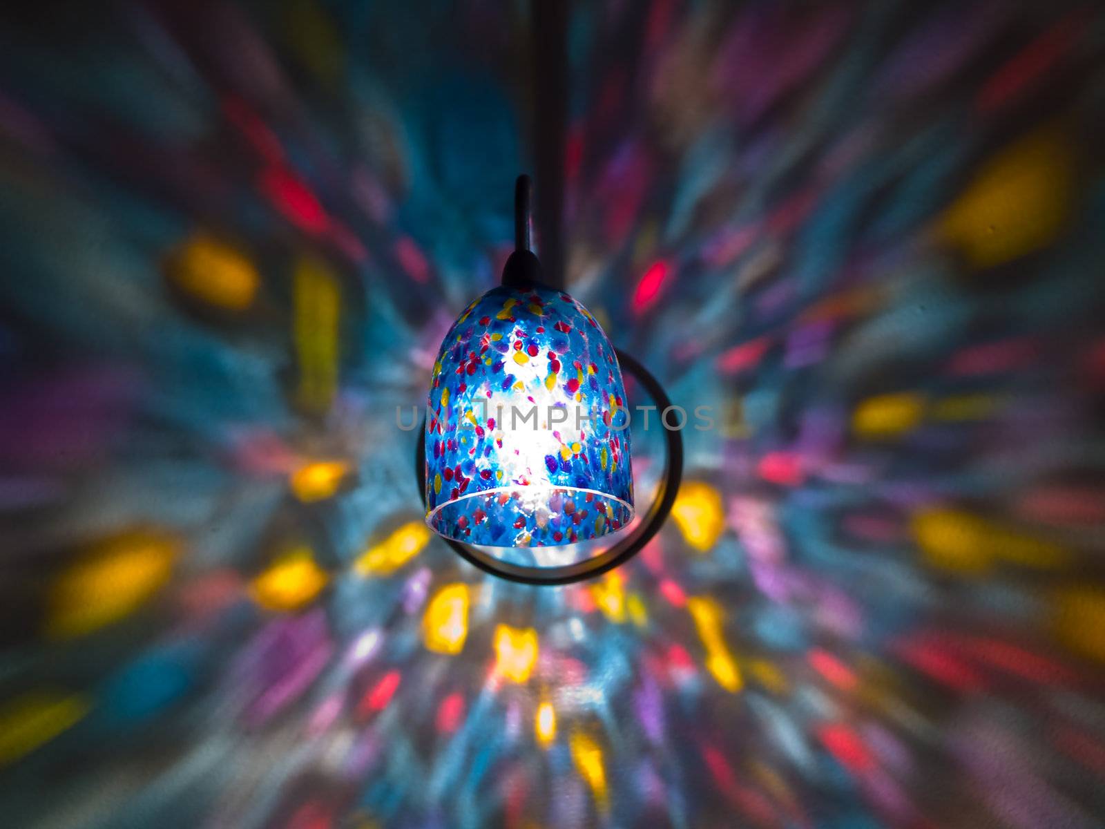 Lamp Lights in a Rainbow Sconce on a Wall