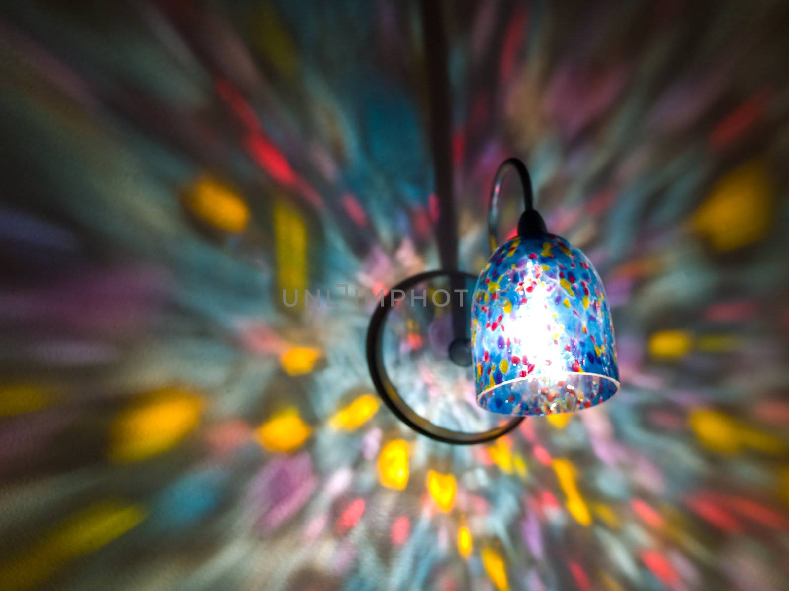 Lamp Lights in a Rainbow Sconce on a Wall
