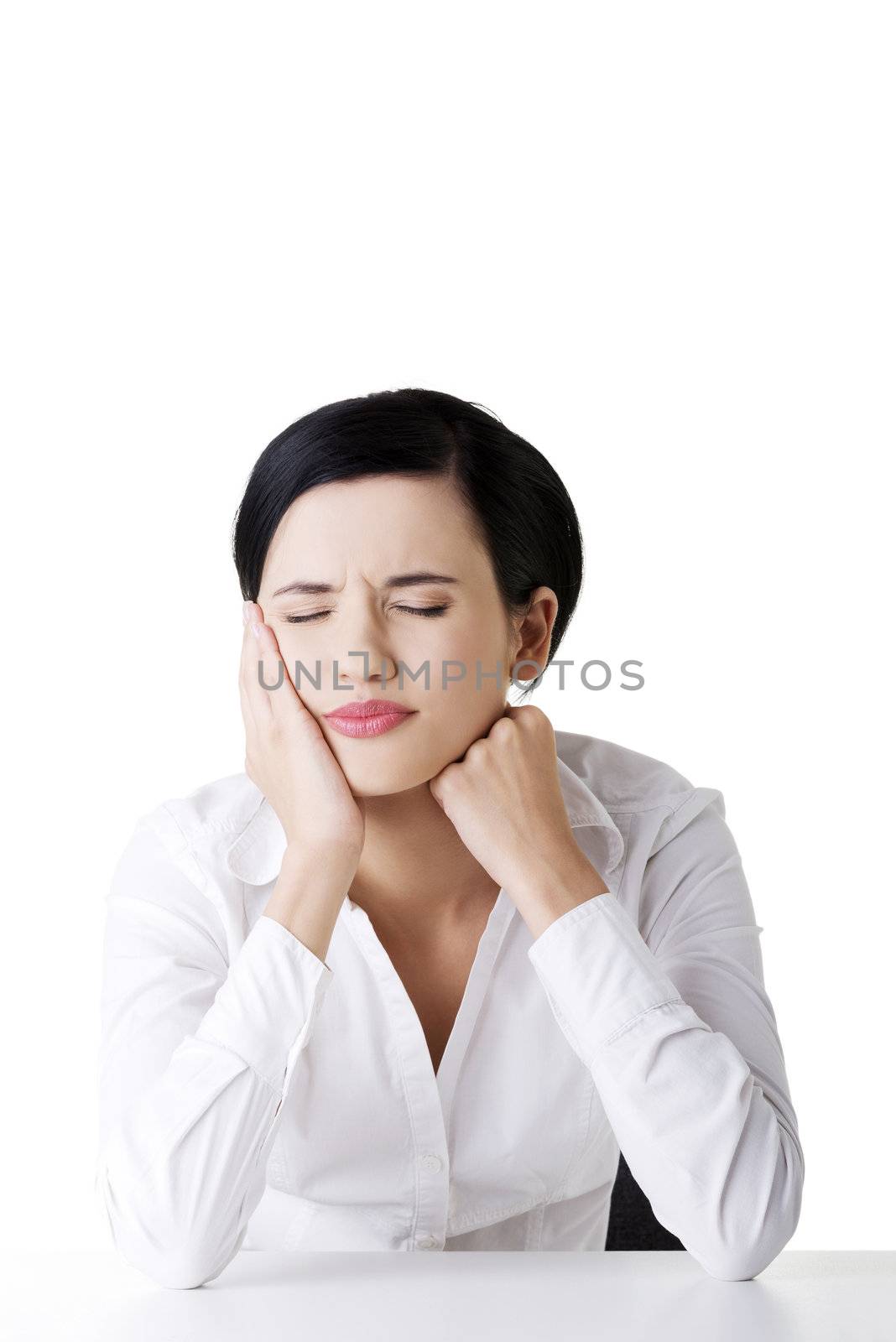 Young woman in pain is having toothache isolated on white