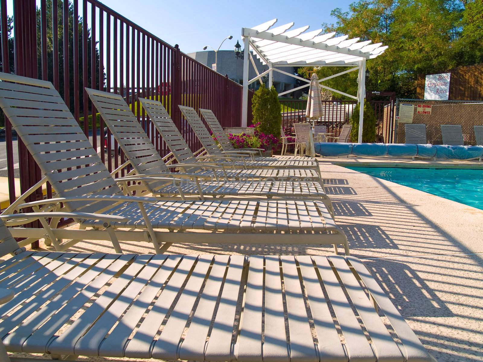 Lounge chairs by the pool on a sunny day