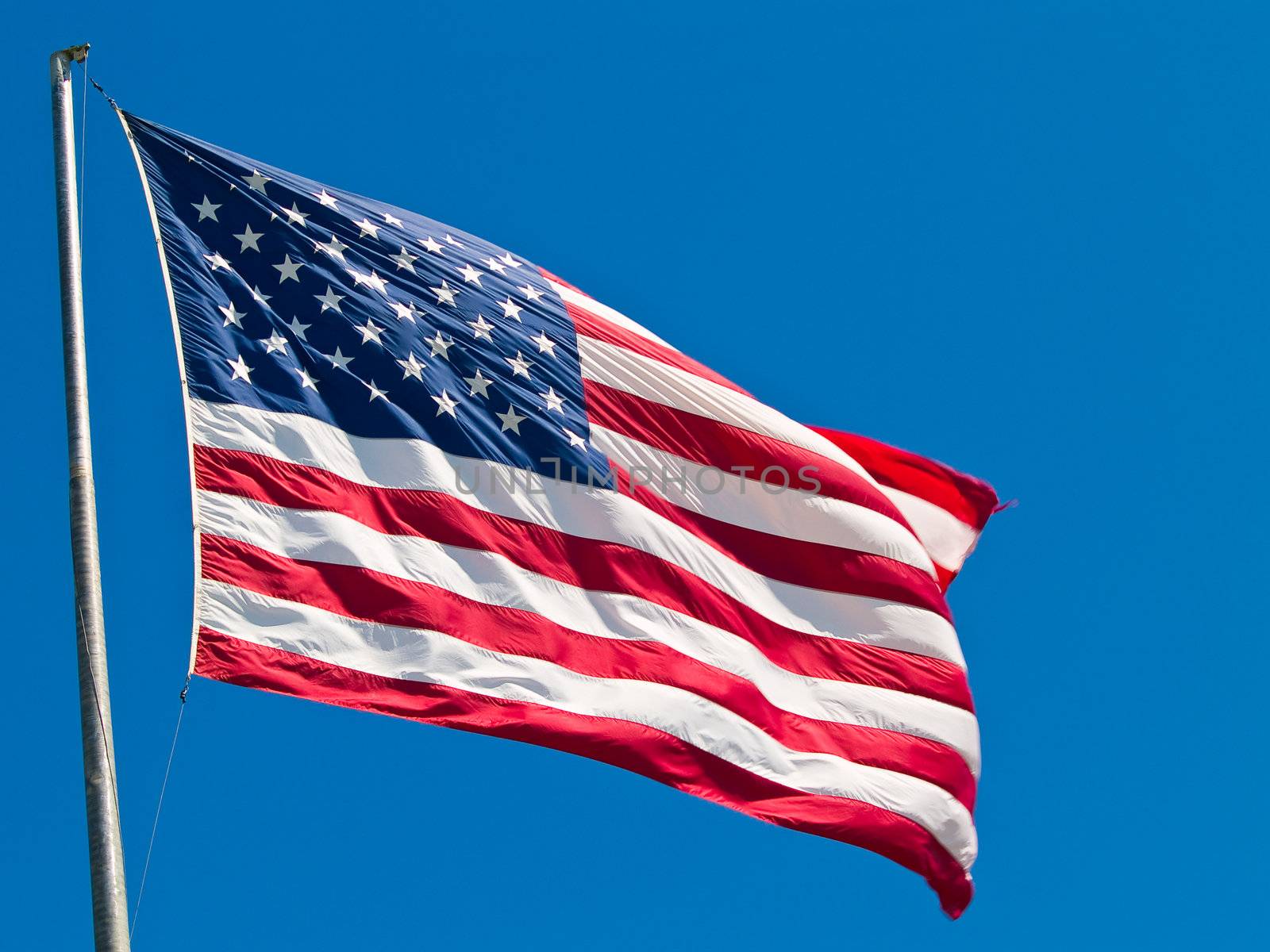 American Flag Waving Proudly on a Clear Windy Day by Frankljunior