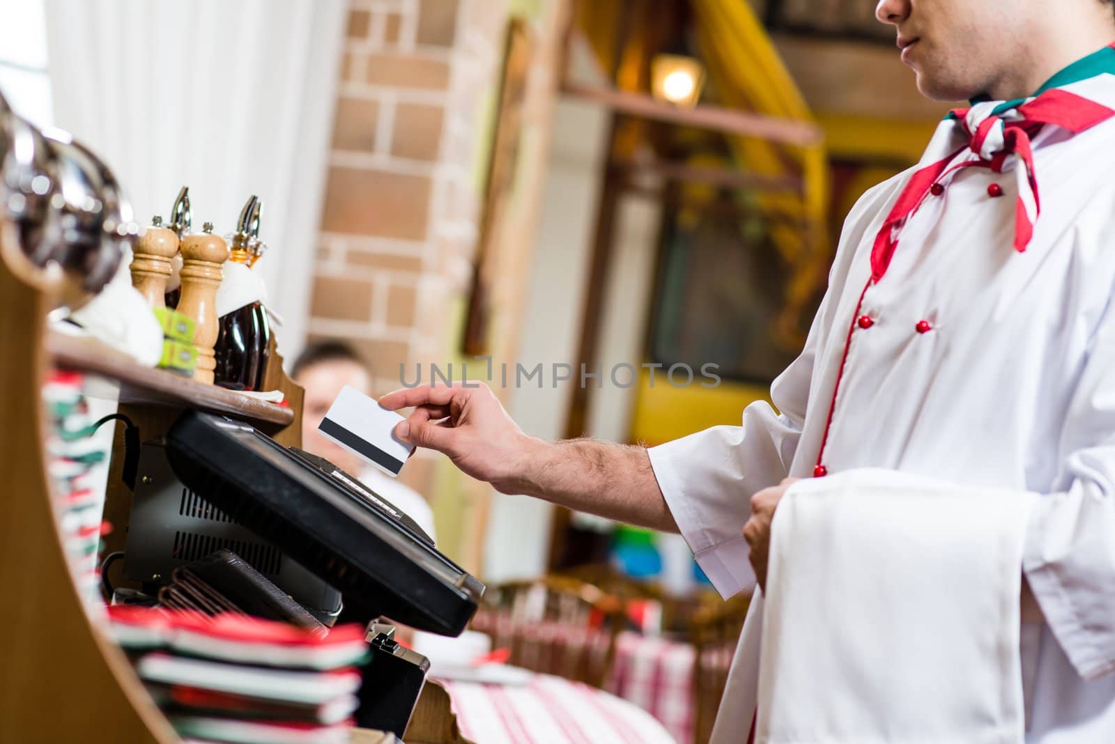 waiter inserts the card into a computer terminal, against visiting the restaurant