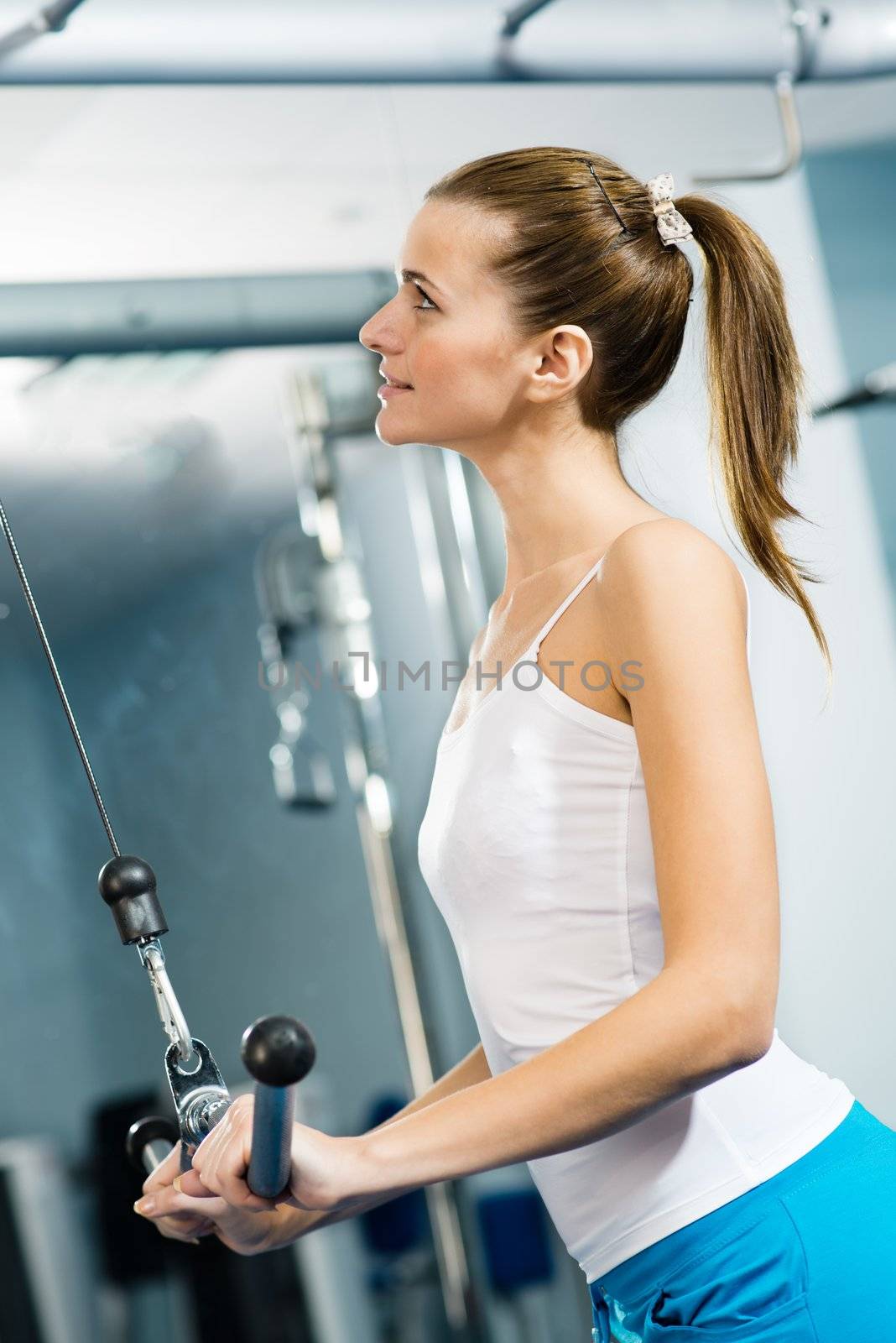 young woman doing body-building in the Gym by adam121