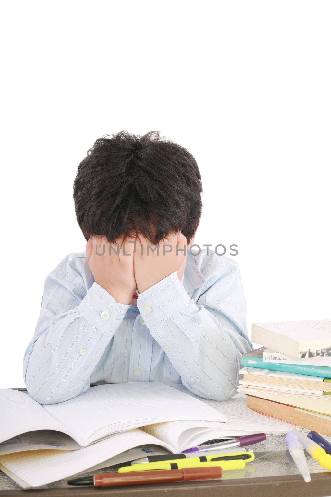 Stressed schoolboy studying in classroom by dacasdo