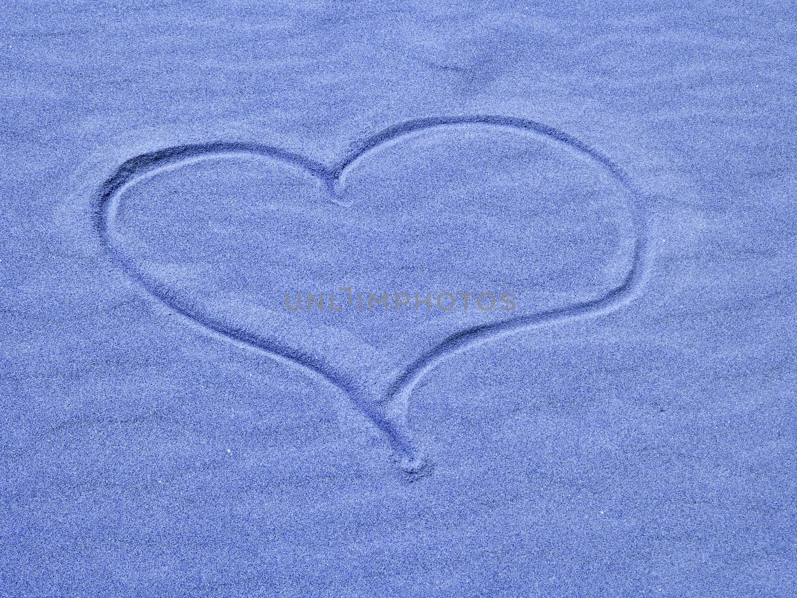 Blue Heart in the Sand on a Sunny Day