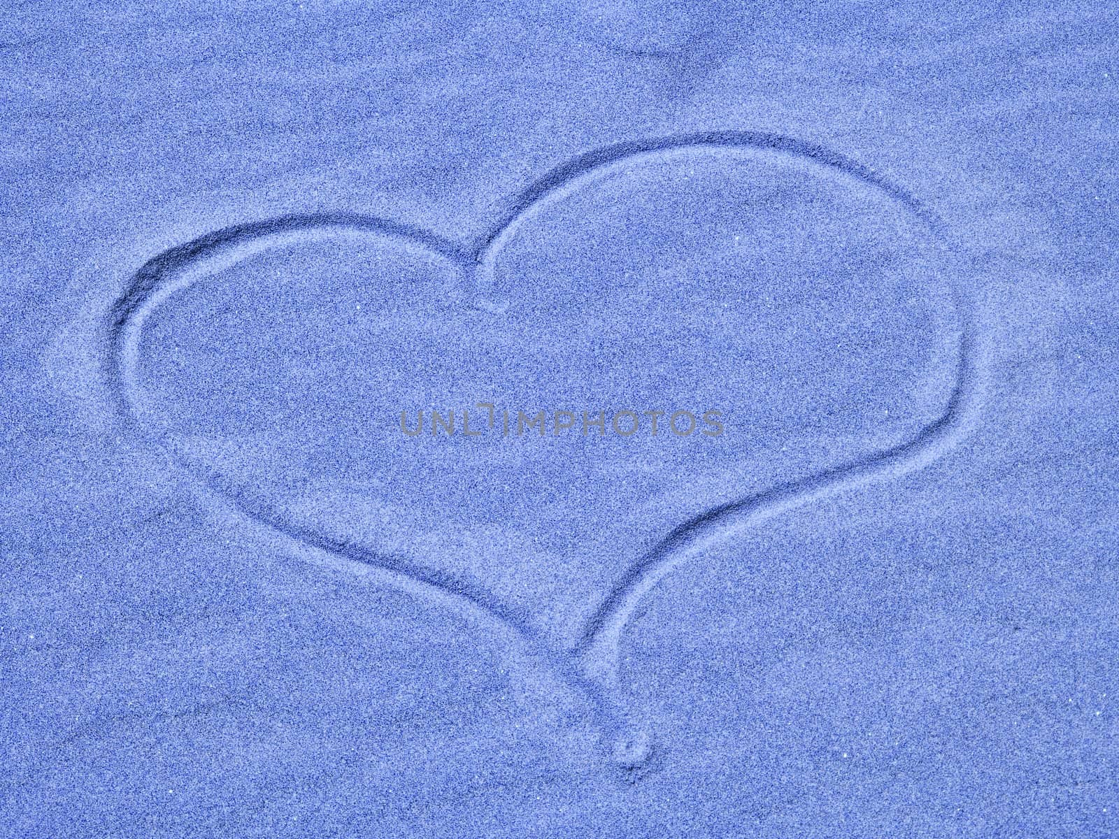 Blue Heart in the Sand on a Sunny Day