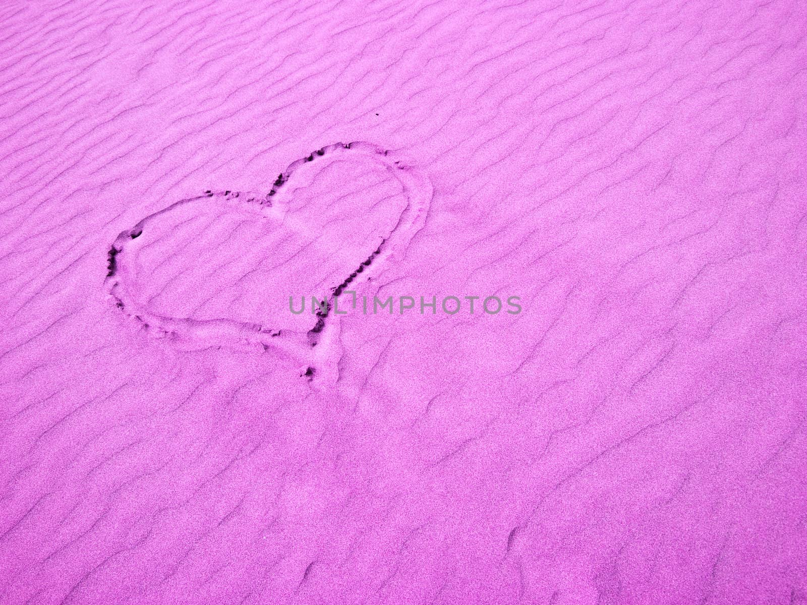 Pink Heart in the Sand on a Sunny Day