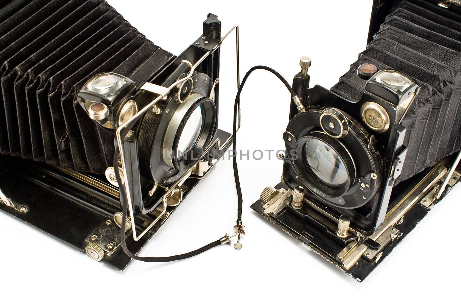 Two Old Cameras "holding hands" isolated on white