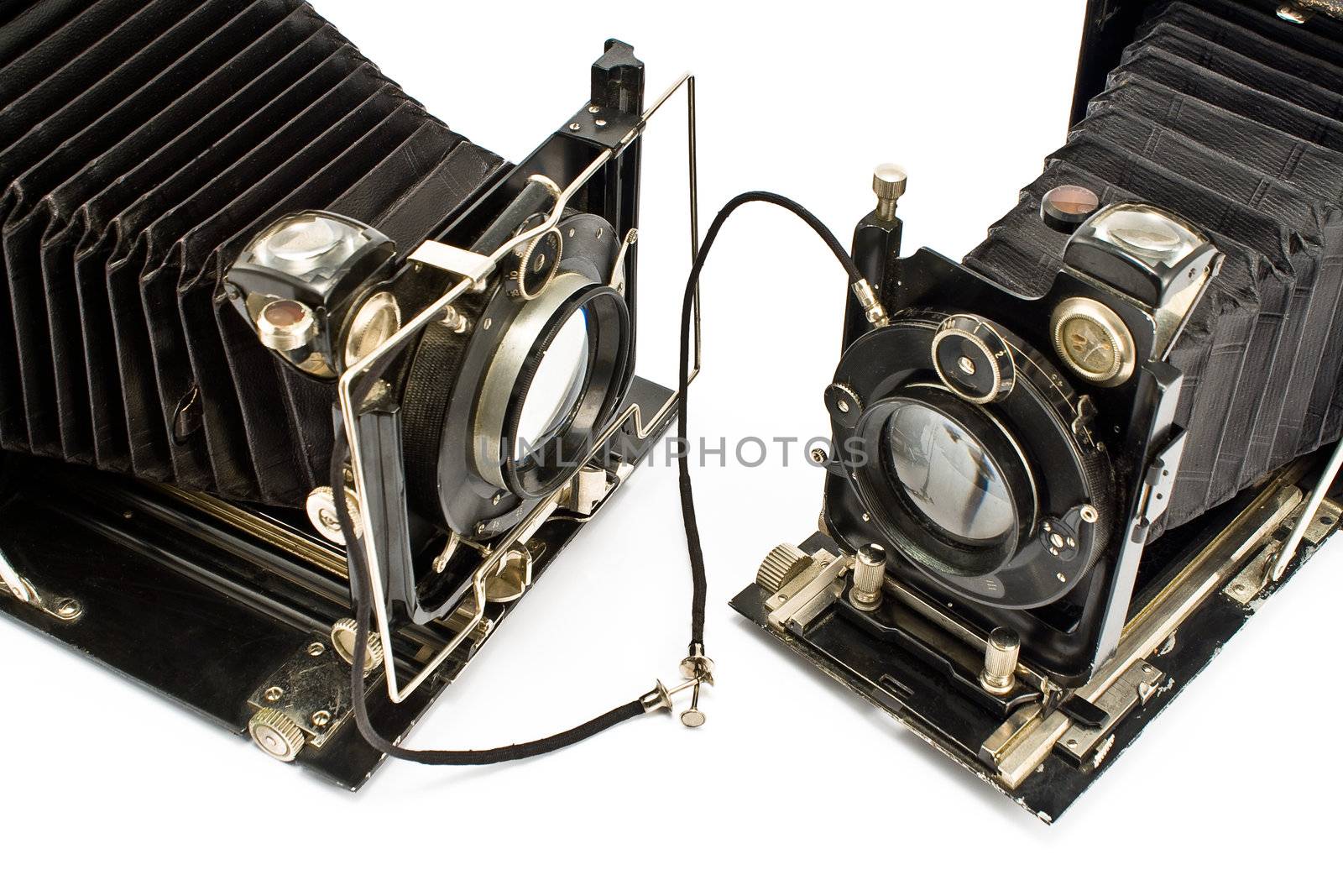 Two Old Cameras "holding hands" isolated on white