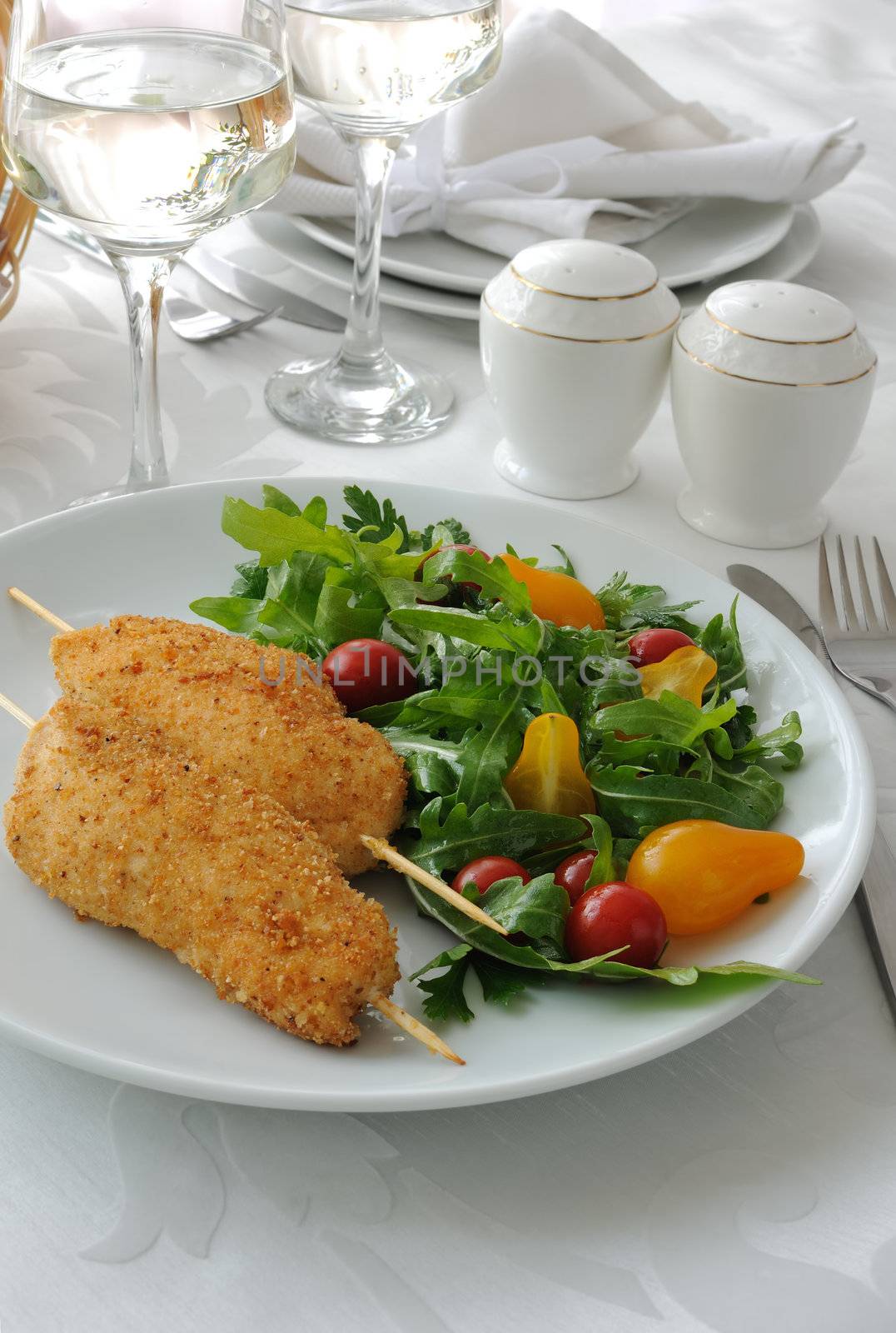 Chicken schnitzel garnish of arugula and tomatoes