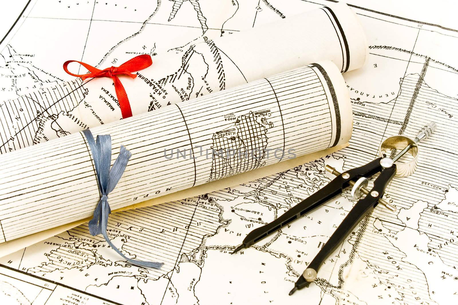 Olda Maps in rolls with ribbons and compass