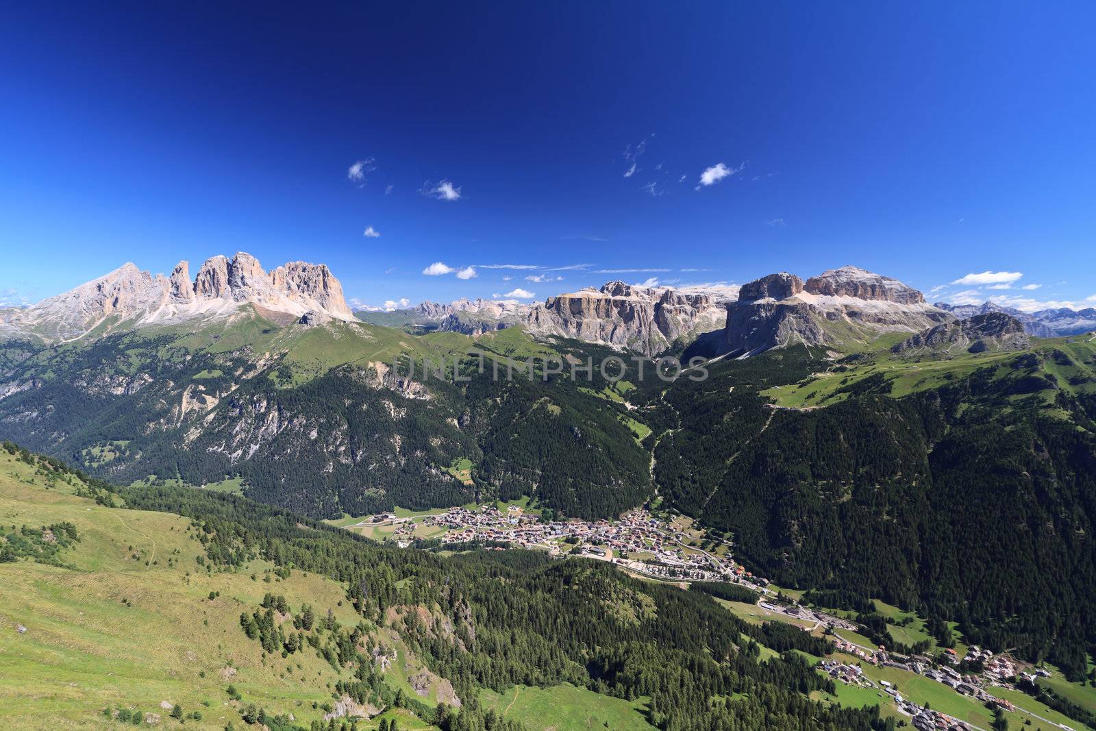Aerial view of Canazei and Fassa valley with Saas Pordoi mount, Sella and Pordoi pass and Sassolungo mount