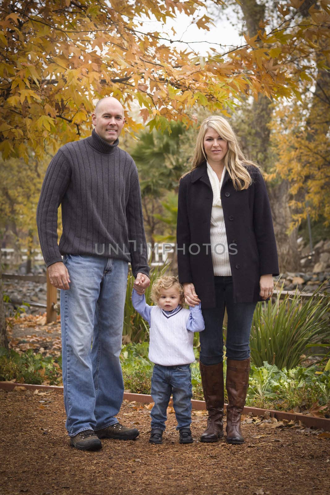 Young Attractive Parents and Child Portrait in Park by Feverpitched