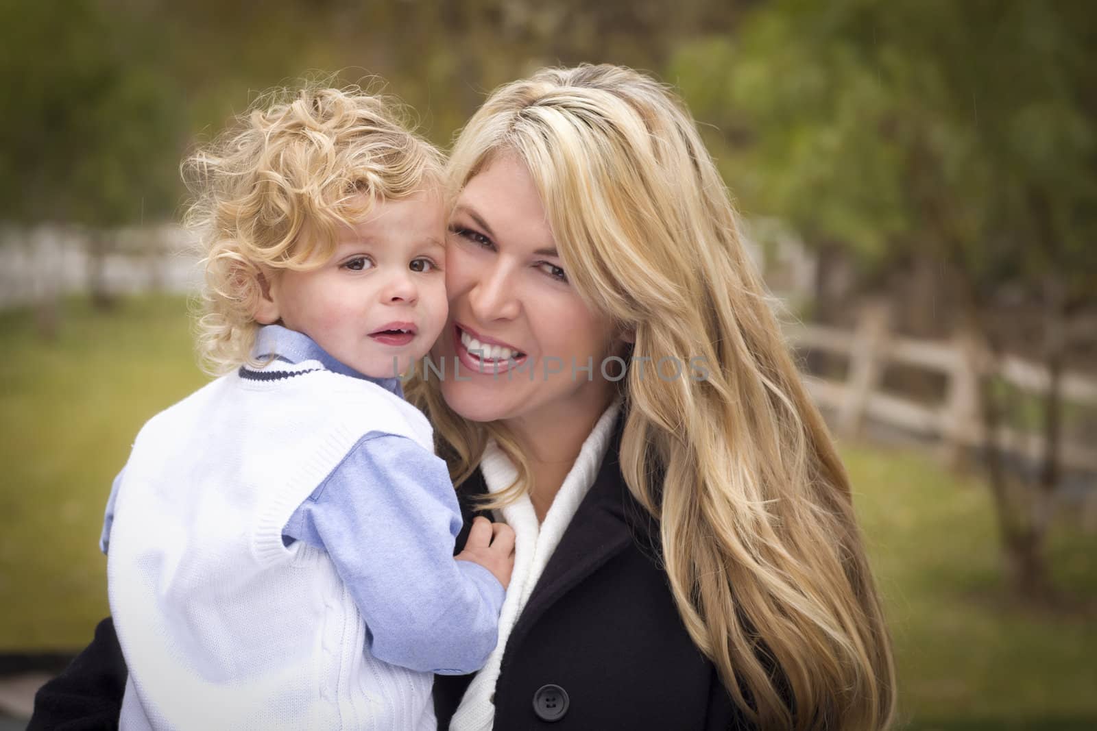 Attractive Mother and Cute Son Portrait Outside at the Park.