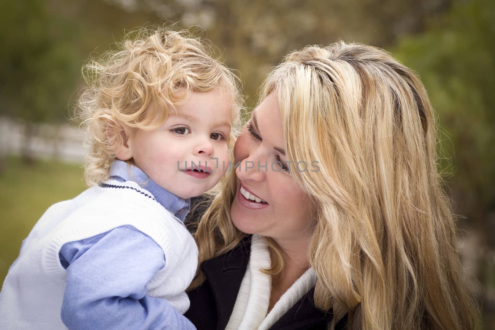 Attractive Mother and Cute Son Portrait Outside at the Park.