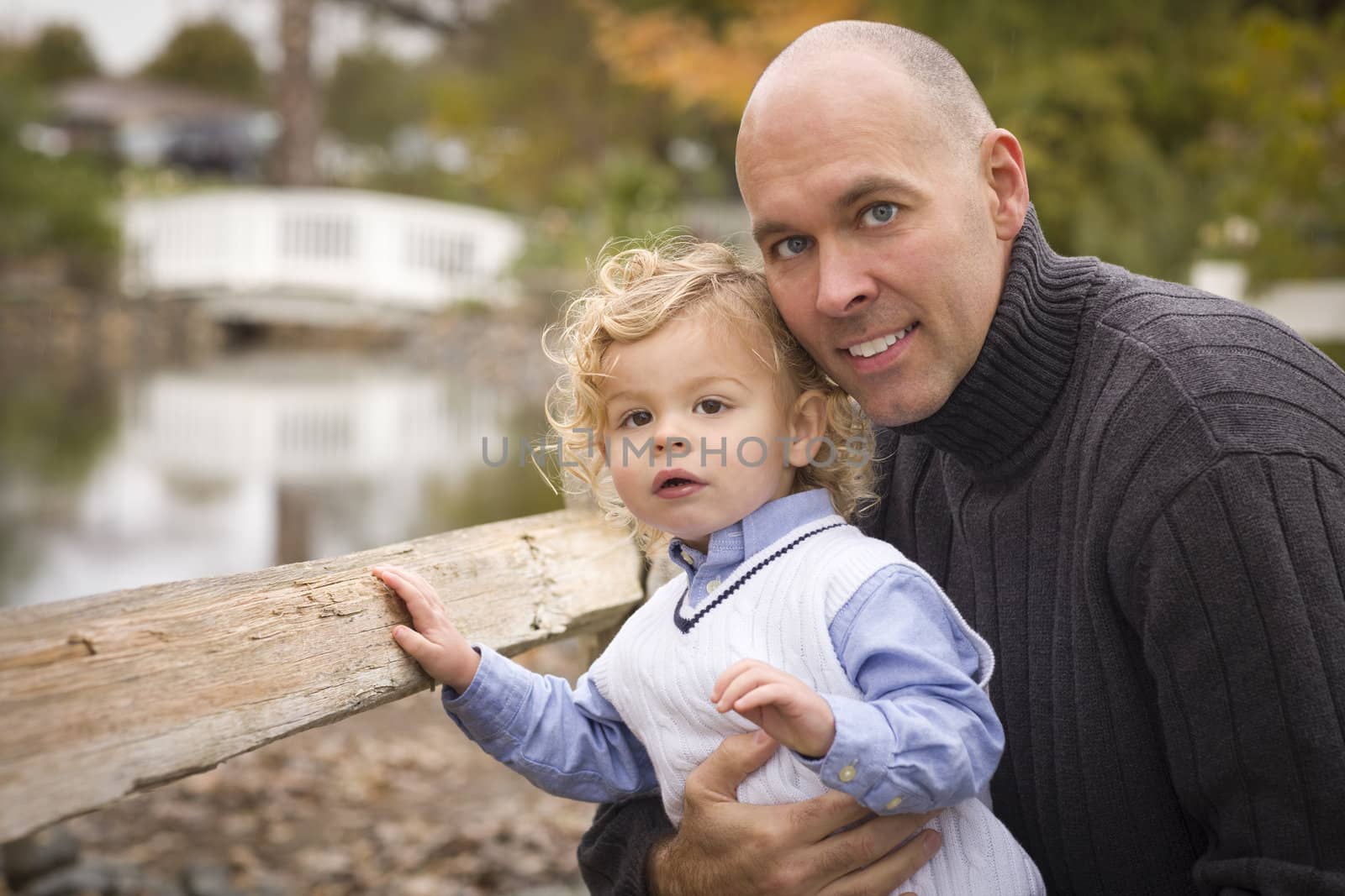 Handsome Father and Son Having Fun in the Park.