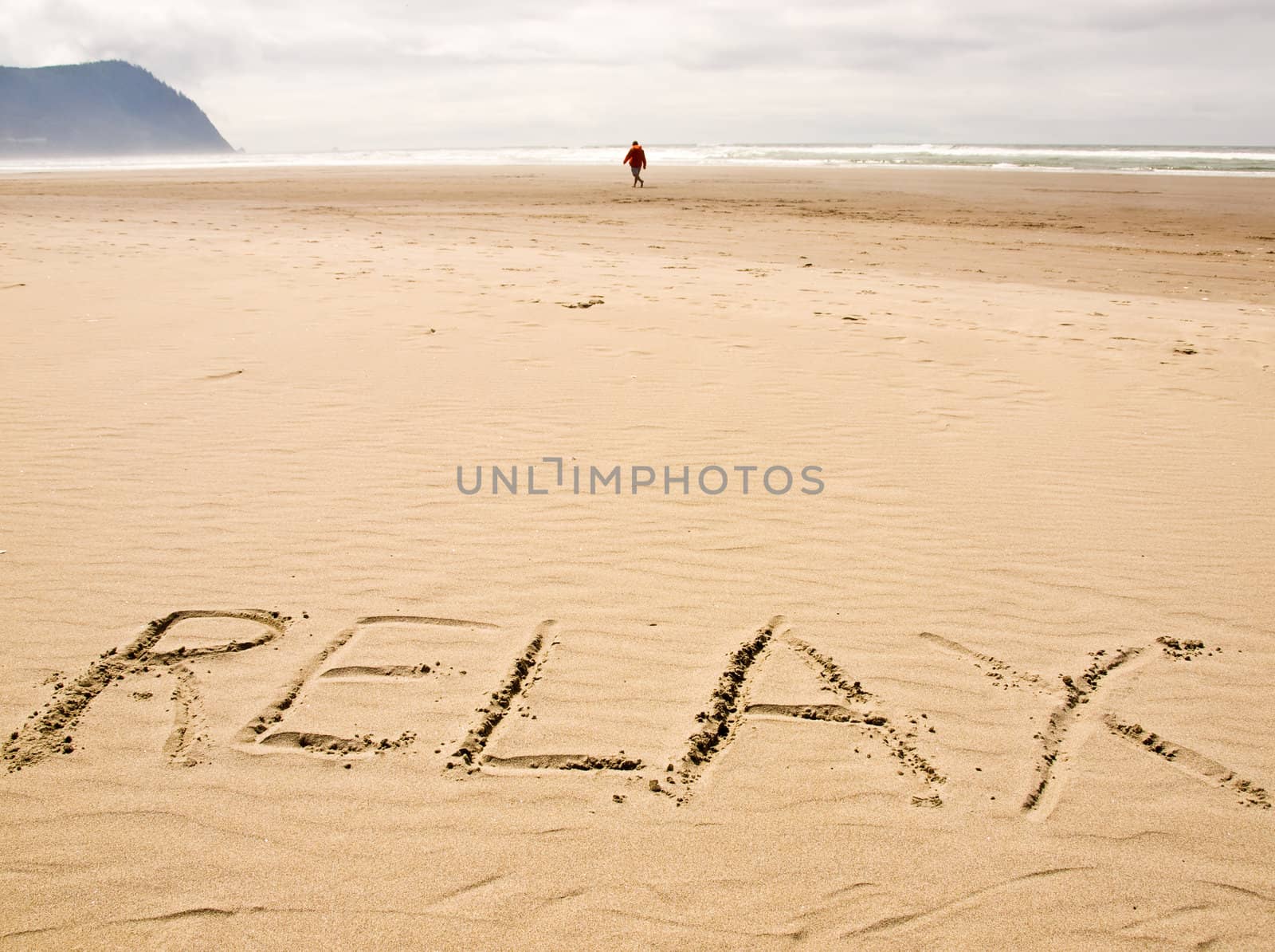 Relax Written in the Sand on a Sunny Day