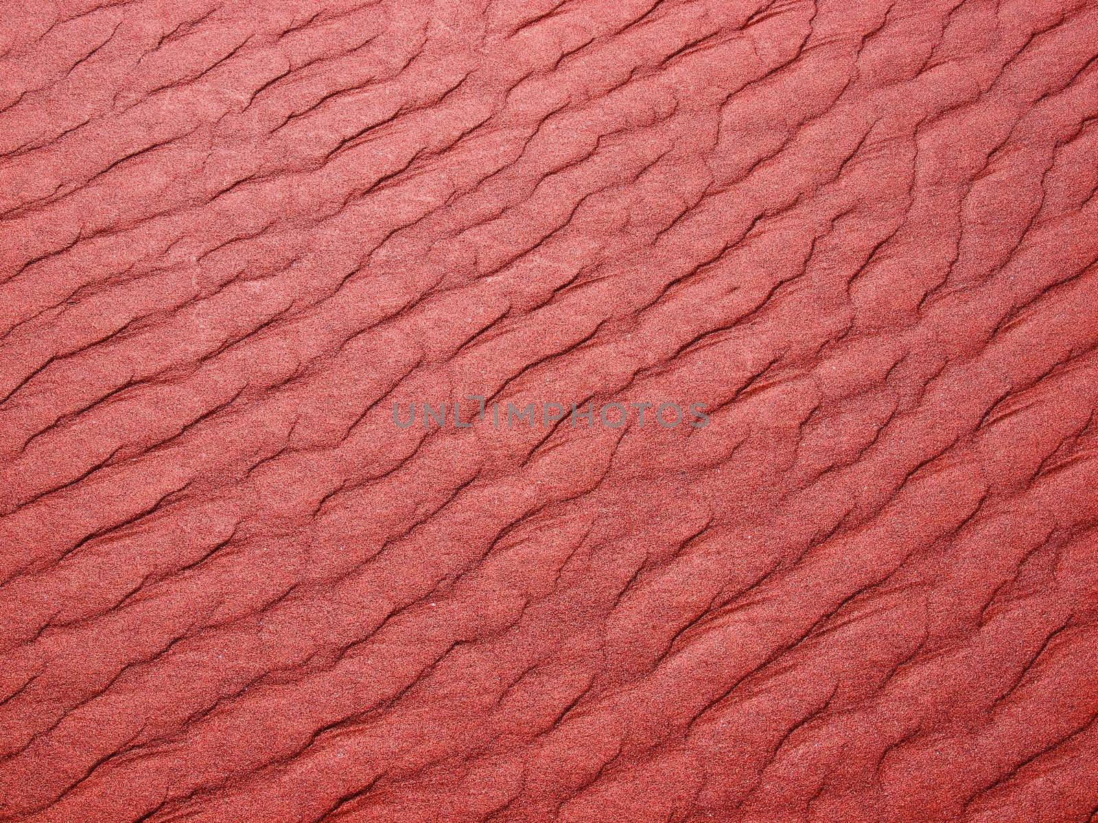 Abstract background of red sand ripples at the beach 