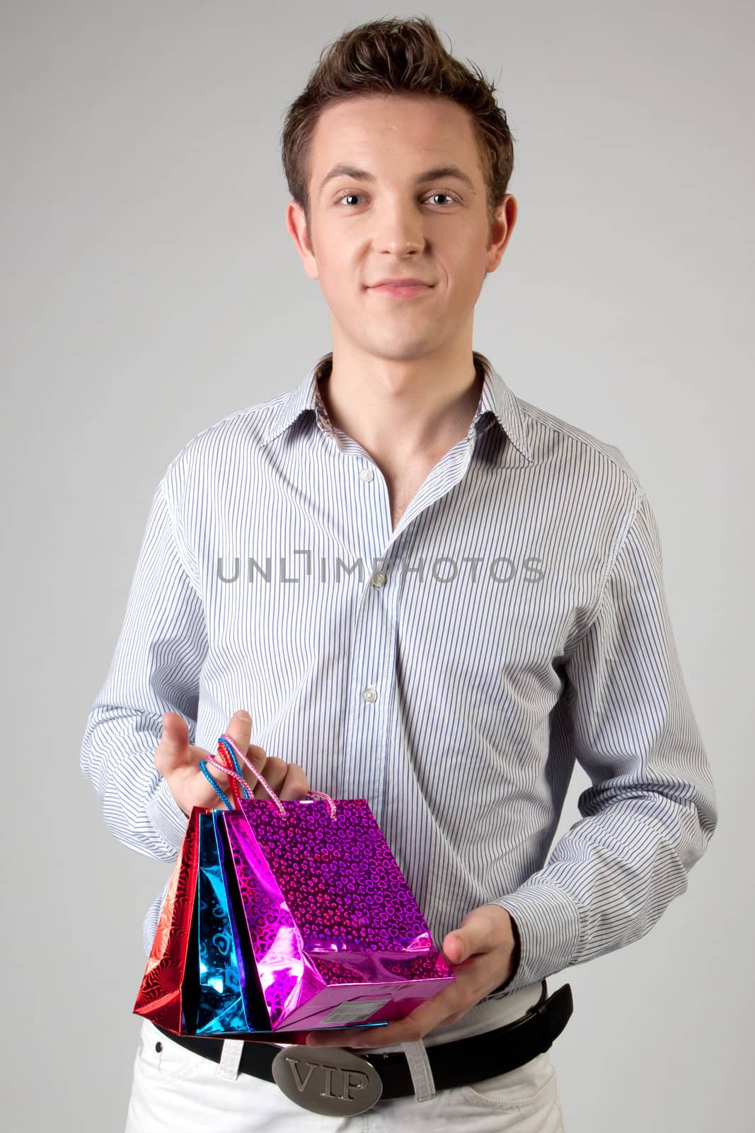Portrait of a young man in formal attire with a New Year's gifts in their hands