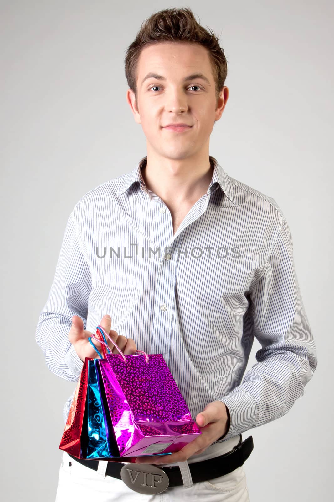 Portrait of a young man in formal attire with a New Year's gifts in their hands