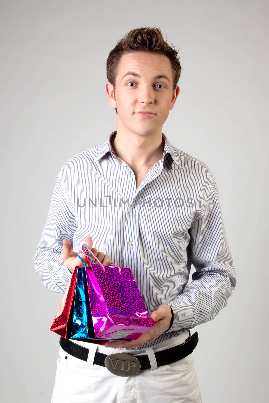 Portrait of a young man in formal attire with a New Year's gifts in their hands