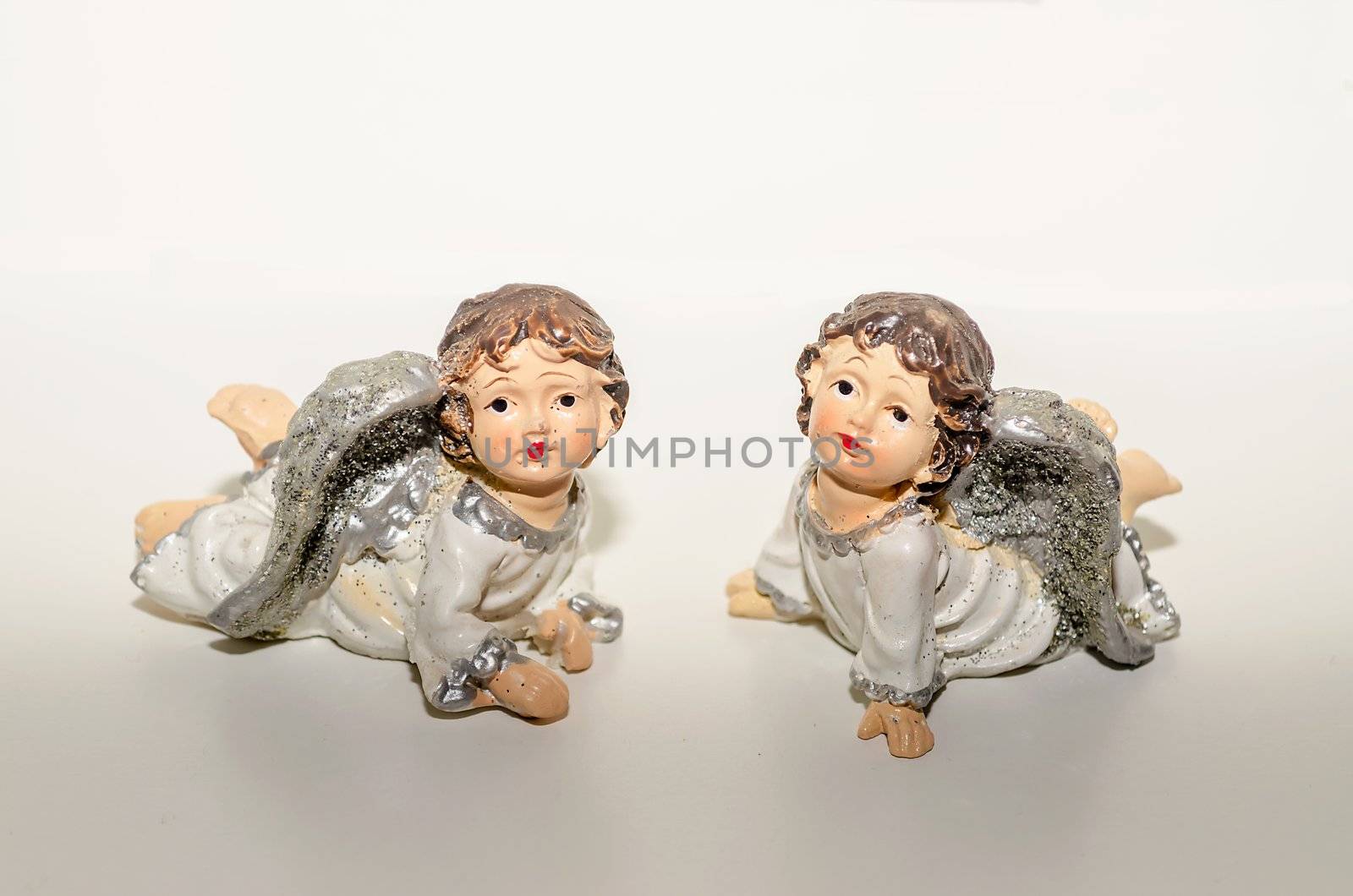 Ceramic Statuette of Two Cute Angels Close To Each Other, isolated on white