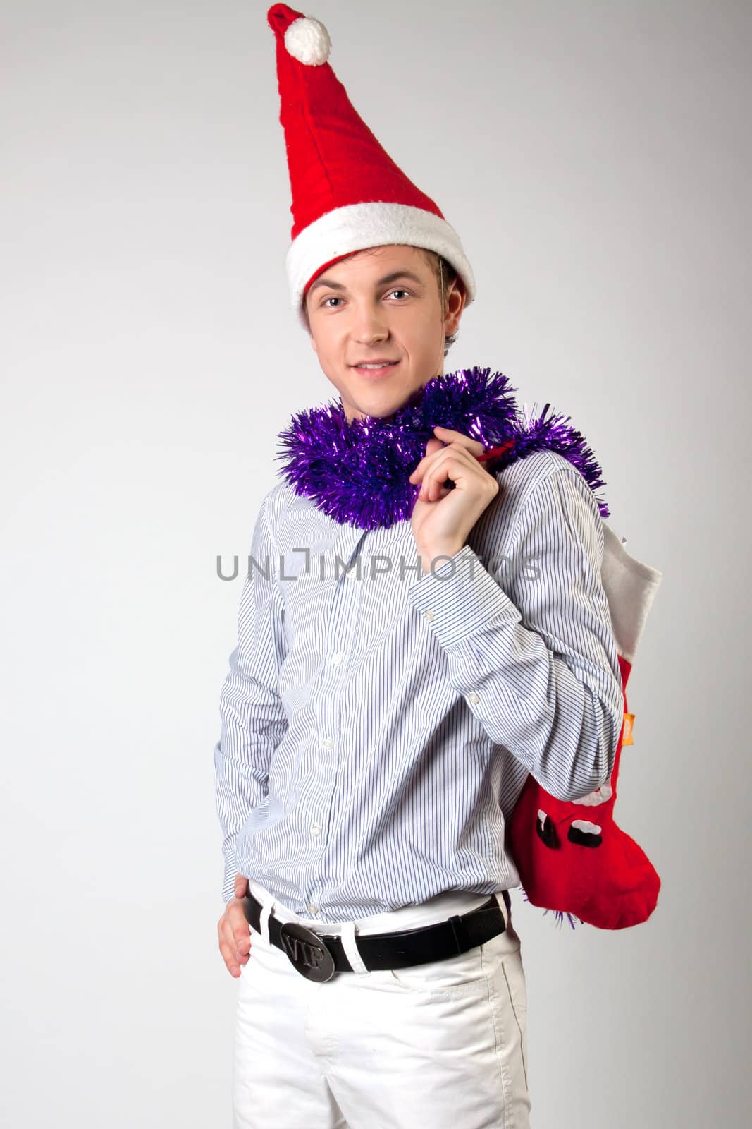 Portrait of a young man in formal attire with a New Year's gifts in their hands