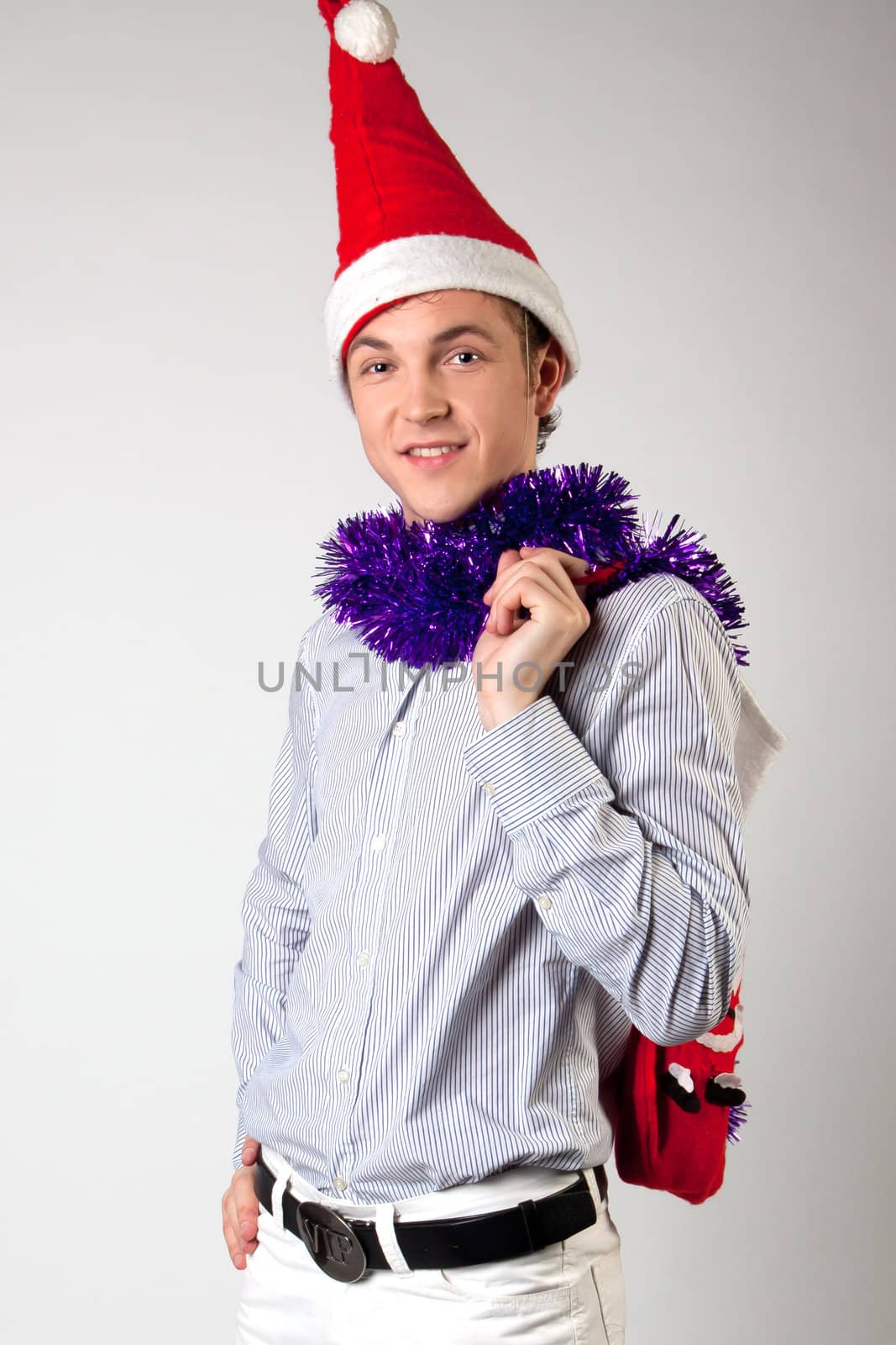 Portrait of a young man in formal attire with a New Year's gifts in their hands