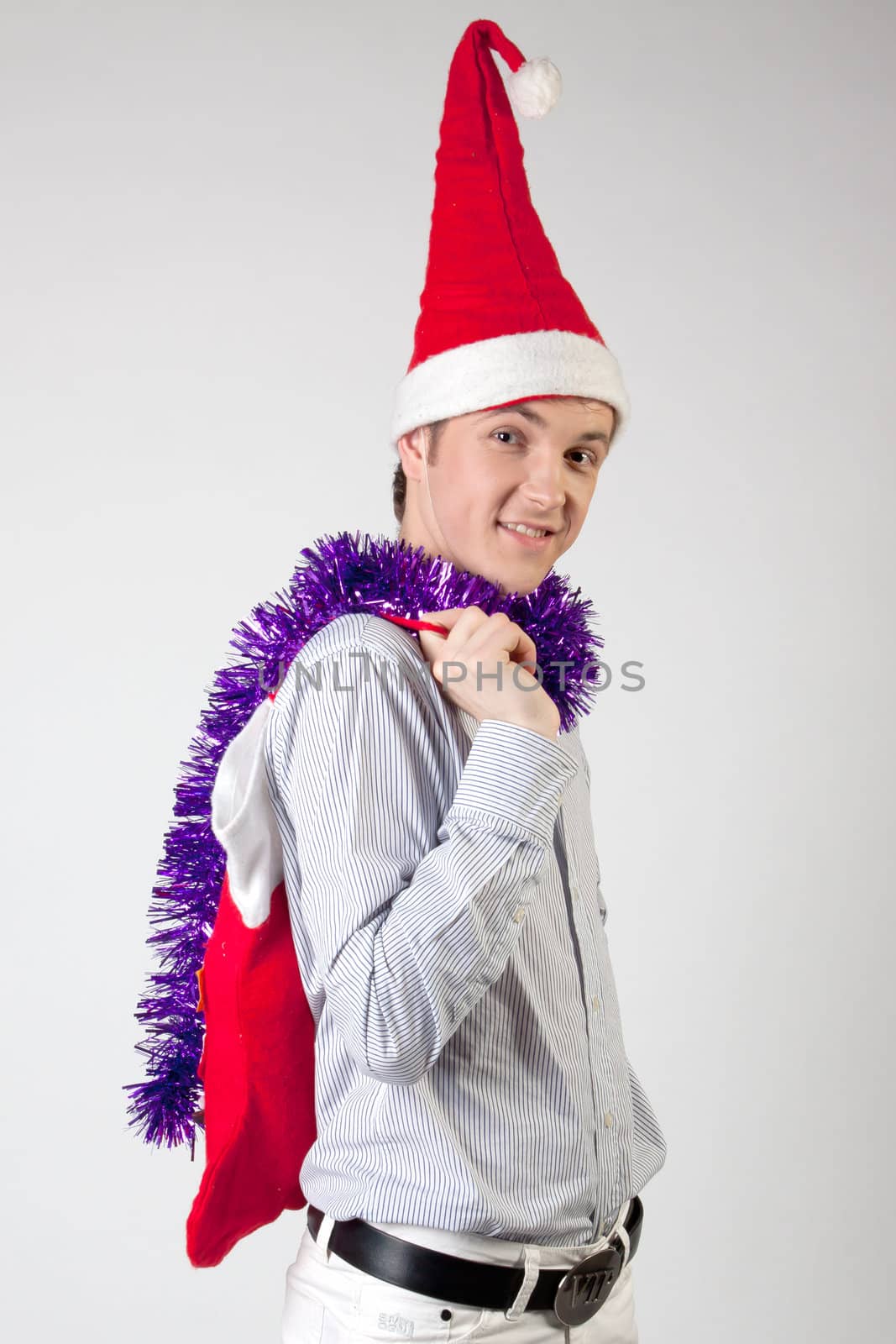 Portrait of a young man in formal attire with a New Year's gifts in their hands