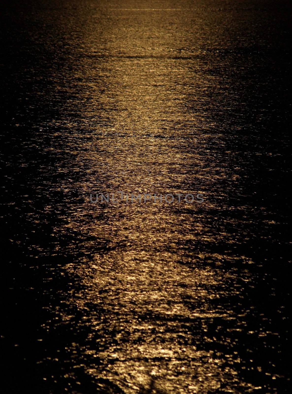 Moon light reflection on calm but rippled water