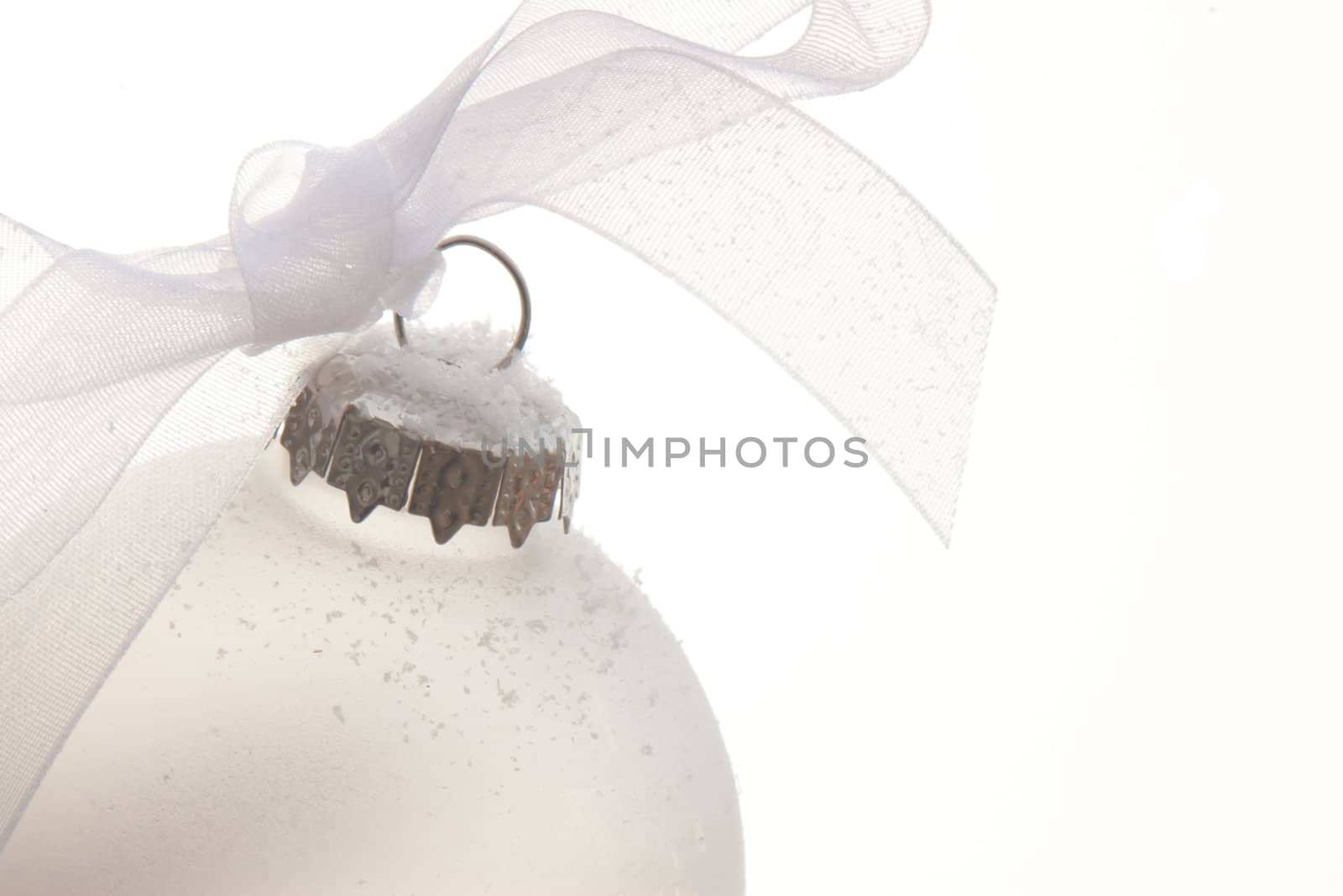 white christmas ornament hanging on a tree